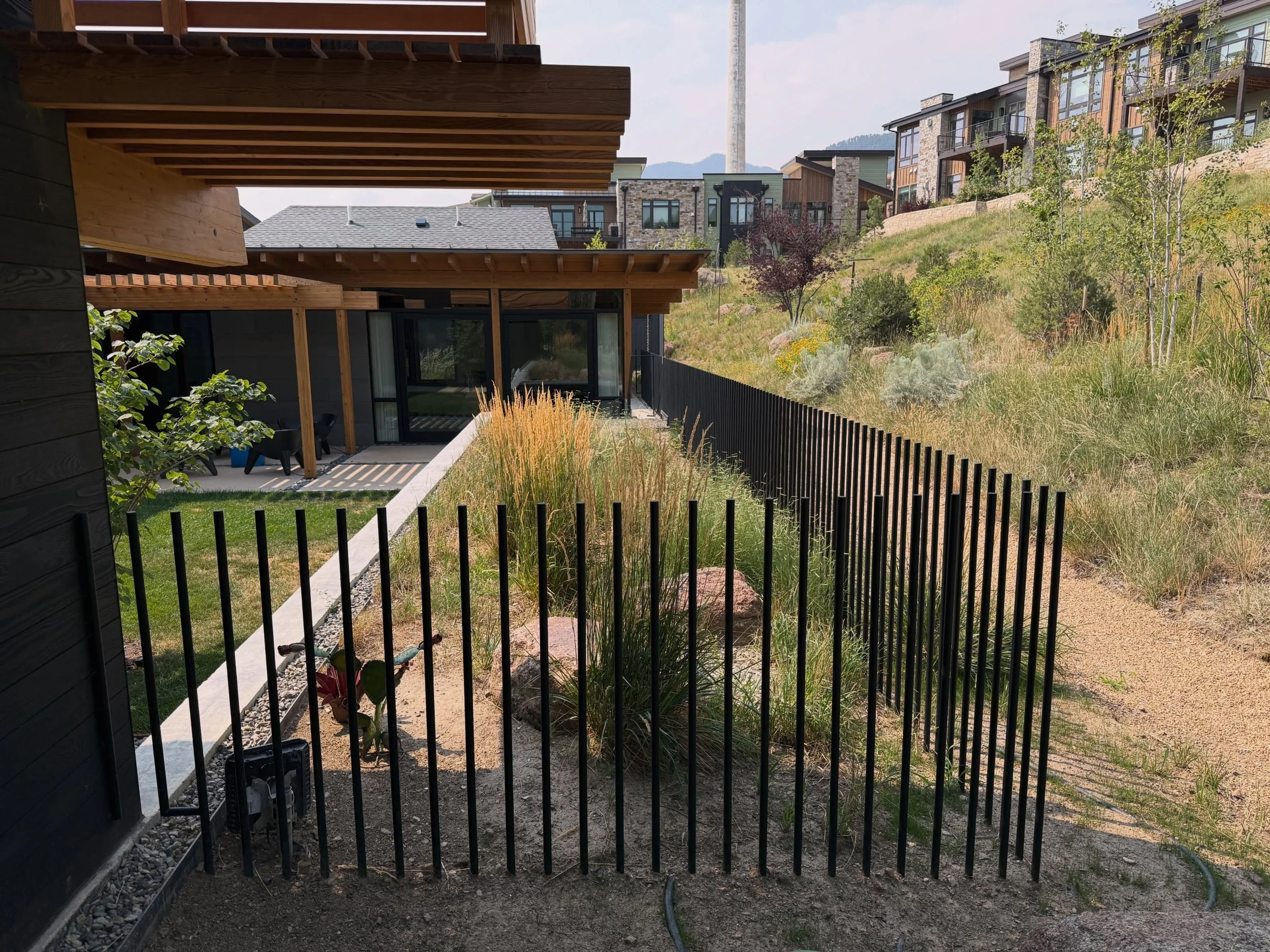 We posted a reel of this fence when we installed it and that got a lot of attention (both positive and negative). 

Now that the dirt is filled back in and vegetation is starting to grow back, you can see the full effect of the design with its visual