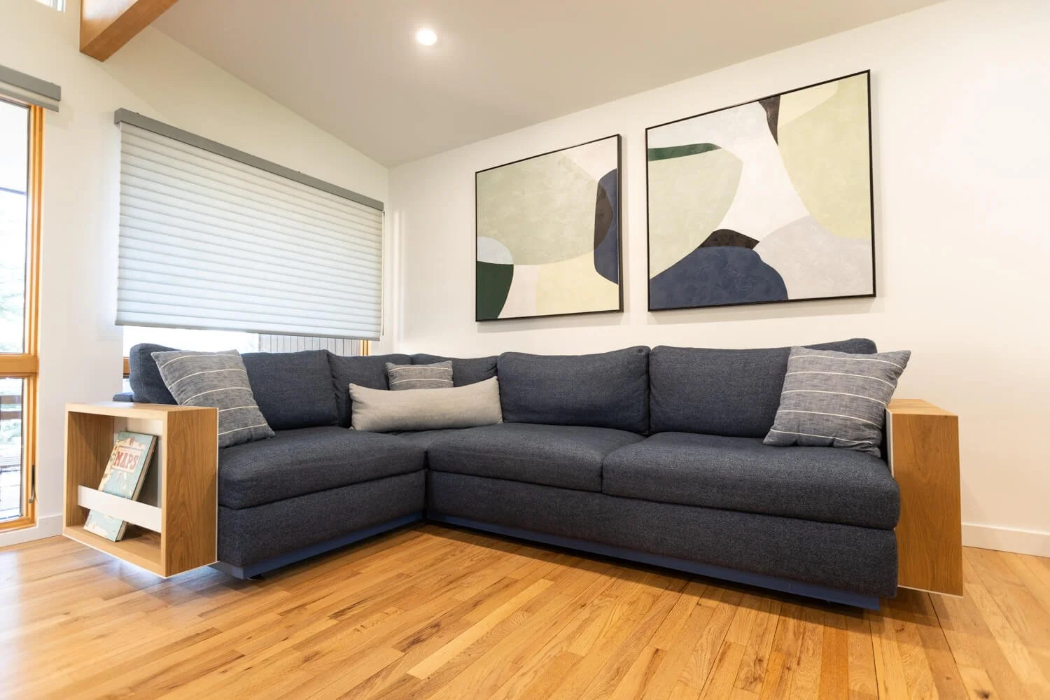 Custom couch modifications including floating white oak and powder coated metal side tables