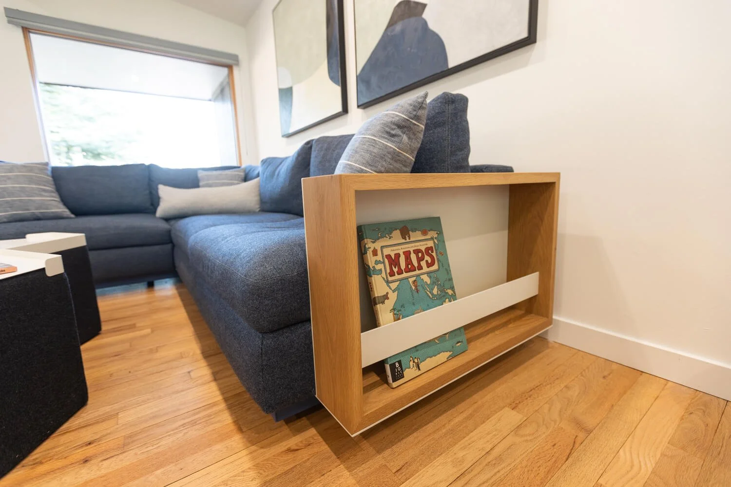 Floating metal and wood side table mounted onto a couch as armrest
