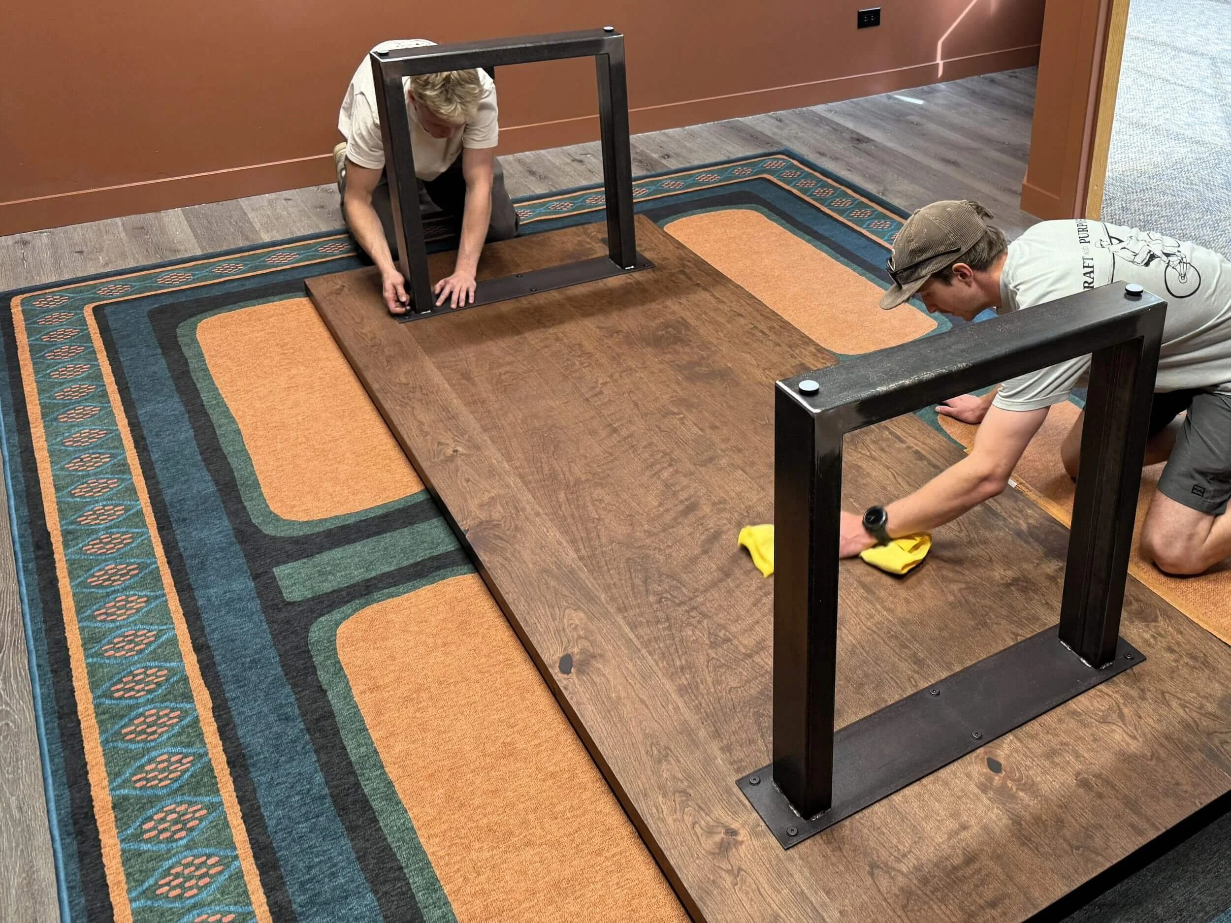 Dust & Spark craftsmen installing a custom conference table