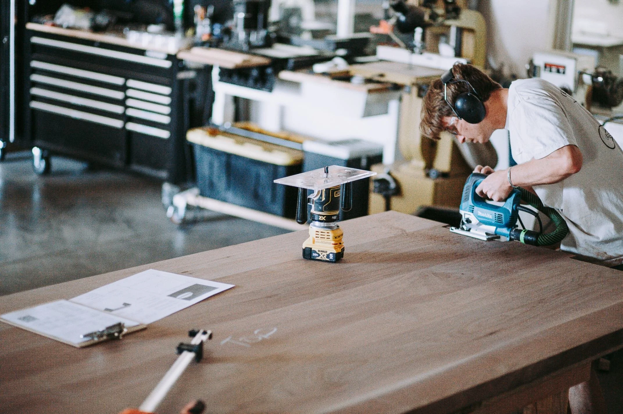 Dust & Spark employee woodworking on a custom table..