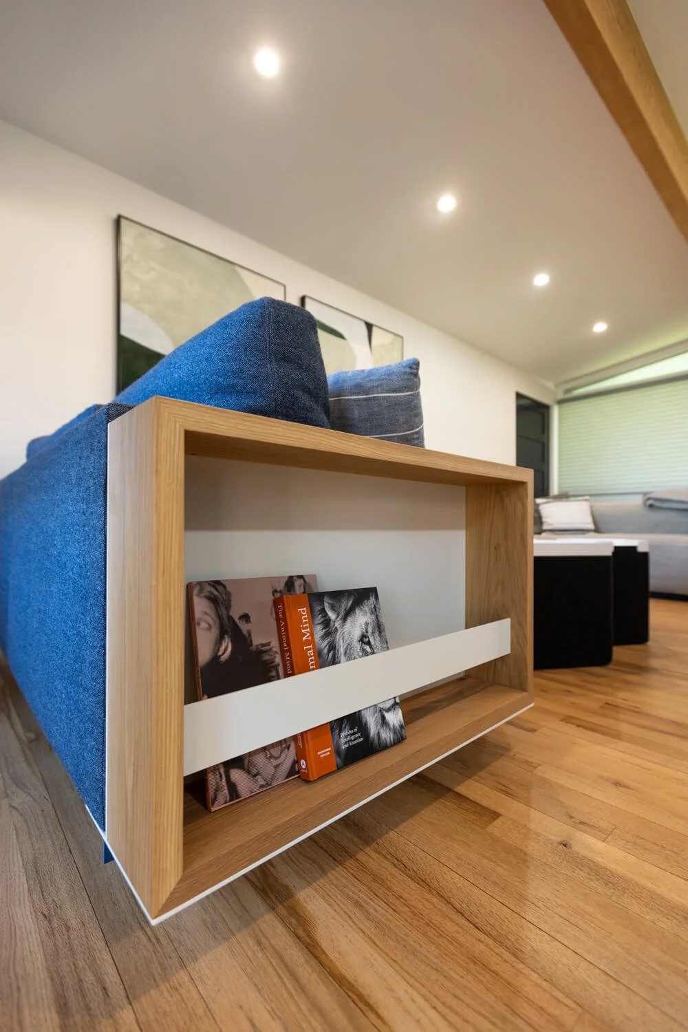 Floating metal and wood side table mounted onto a couch as armrest