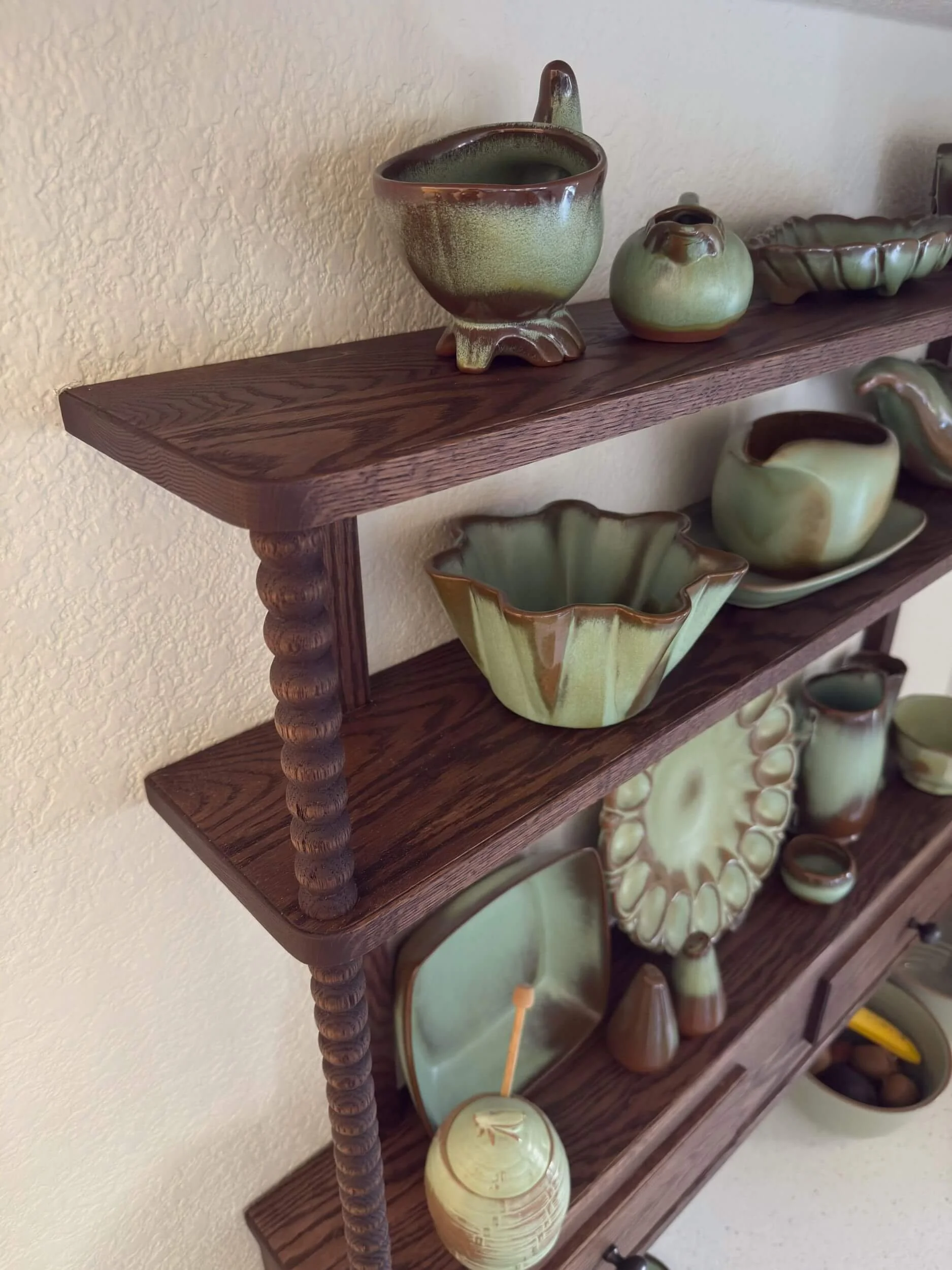 Dark oak display shelving with hand turned spindles