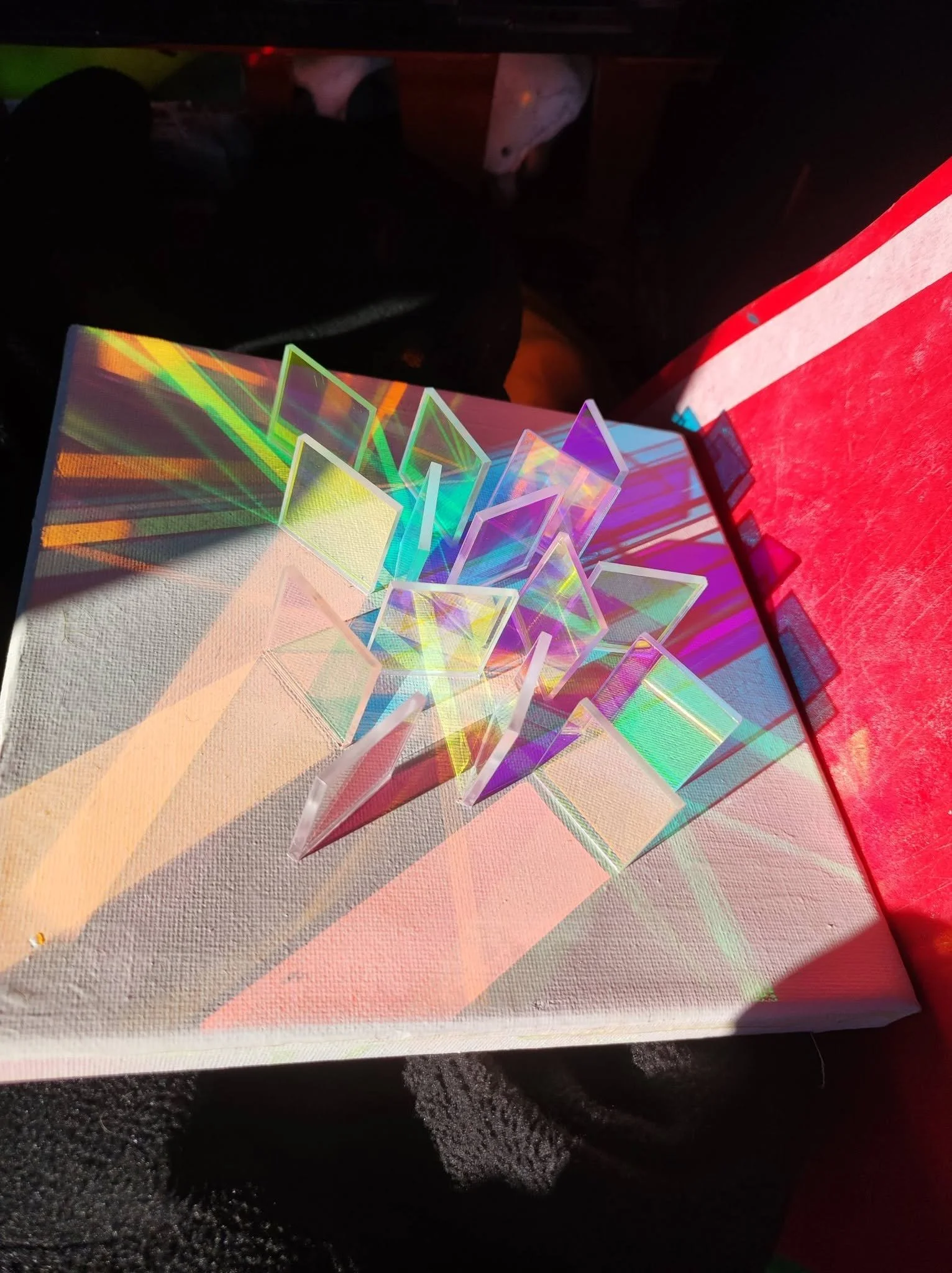 Photo showing artwork made using canvas and iridescent shapes to create a light effect.