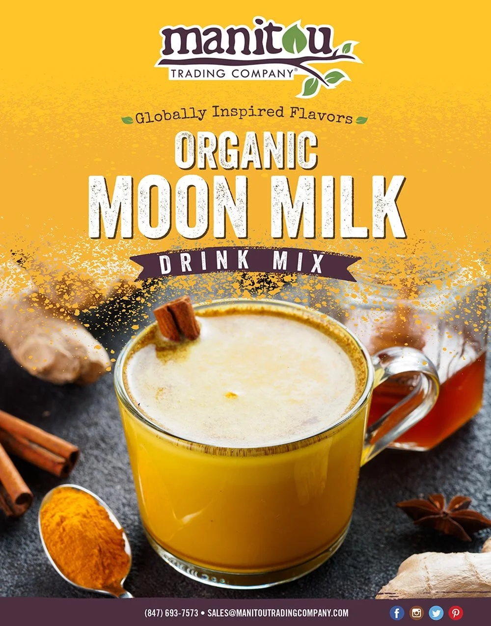 A package of Manitou Organic Moon Milk Drink Mix with a glass of moon milk garnished with a cinnamon stick, surrounded by cinnamon sticks, turmeric, ginger, and star anise on a dark surface.