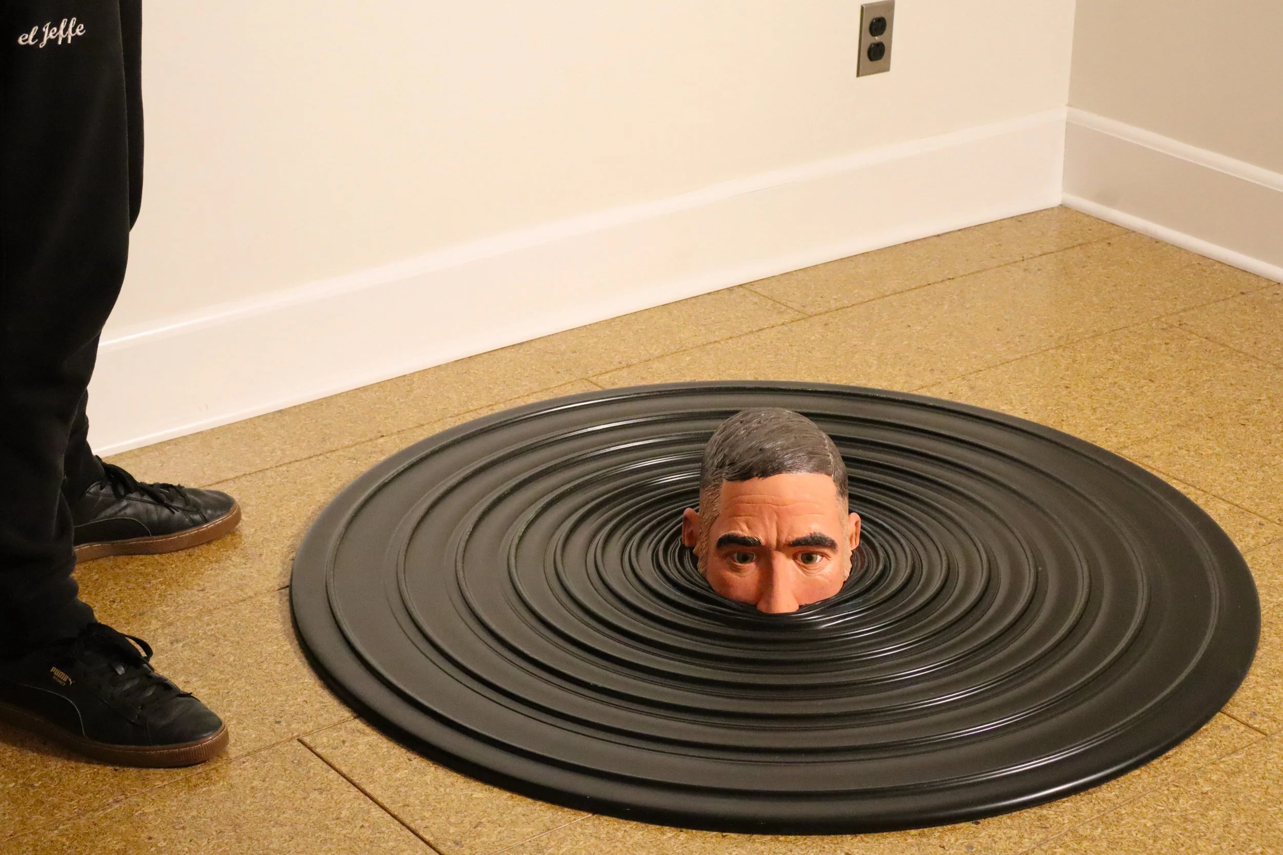 Descending Self Portrait/ Glazed ceramic with paint and polyurethane, on apoxy sculpt, on easy sand 45, on plywood/ 8"x44"x44"/ 2025