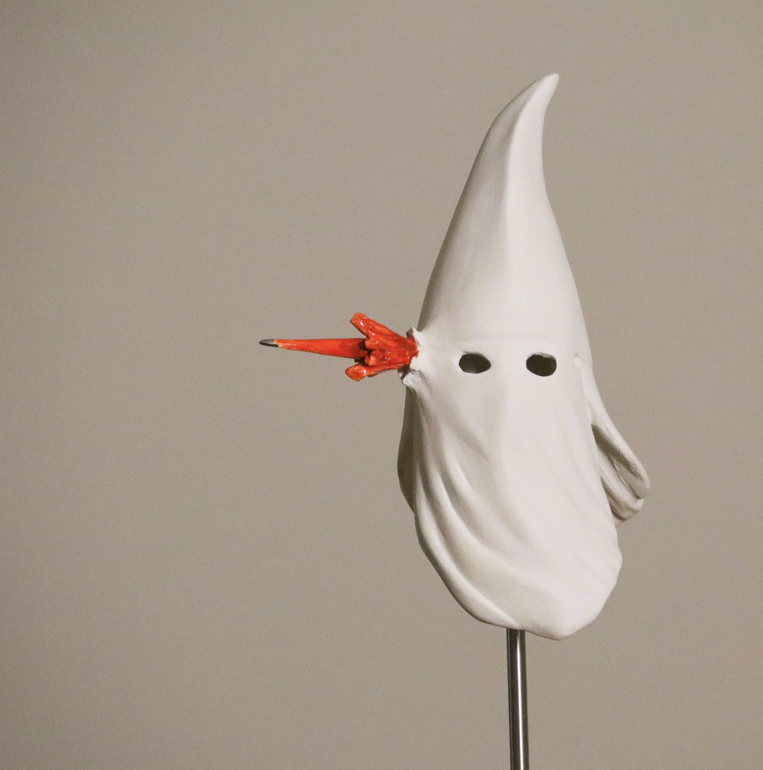 Klan Hood with Exit-wound/ Gesso on glazed and lustered ceramic with stainless steel/ 65"x11.5"x11.5"/ 2023