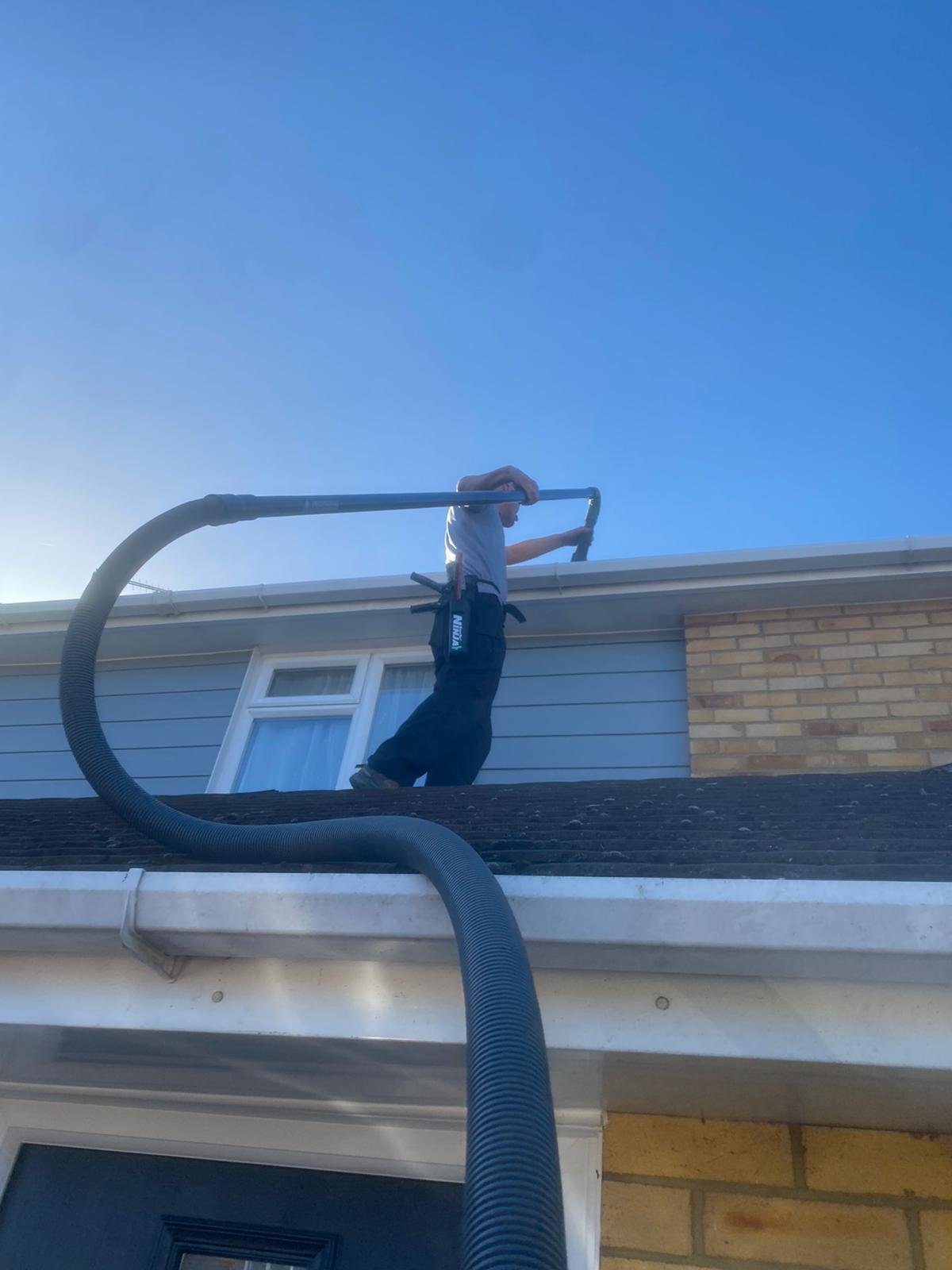 Gutter vac being used from a flat roof