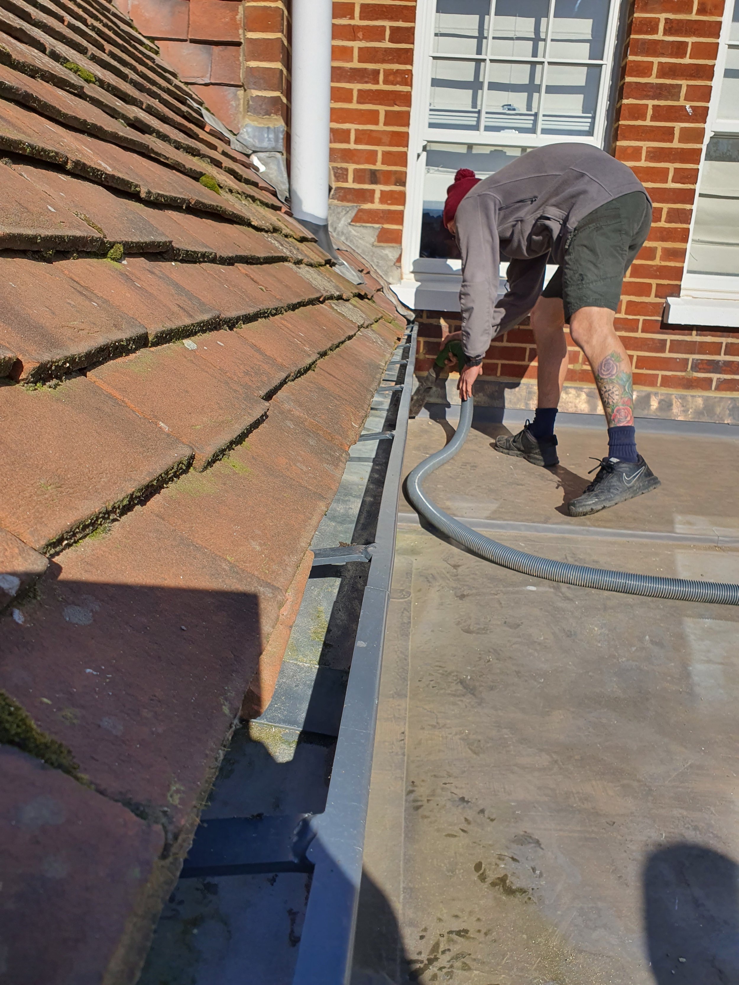 Gutter vac being used from a flat roof