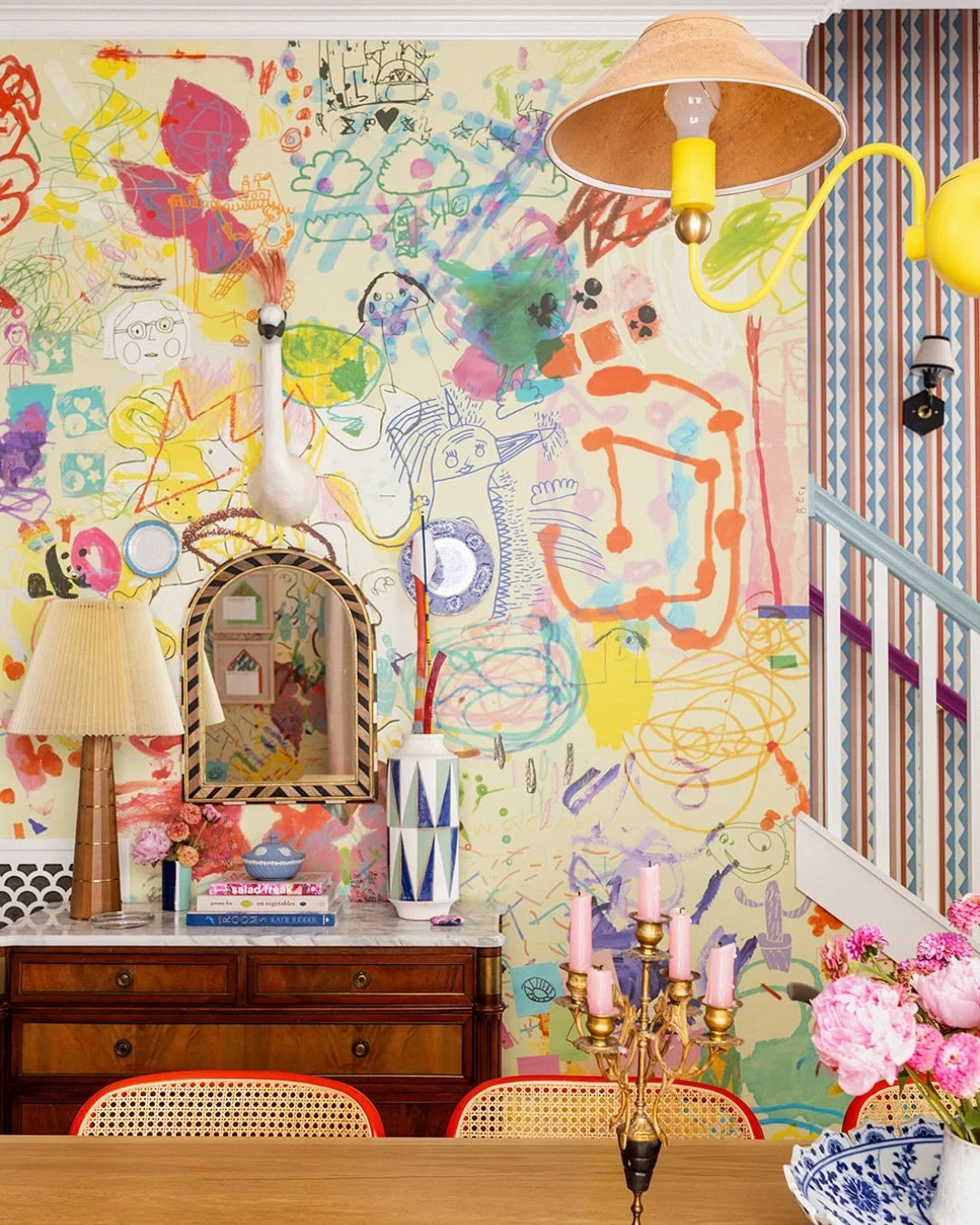 The custom wallpaper in our dining room and kitchen is made entirely from our kids’ artwork; every mark on it came from our 3 kids.  
Years of doodles, scribbles, and masterpieces became a one-of-a-kind wallpaper thanks to the brilli