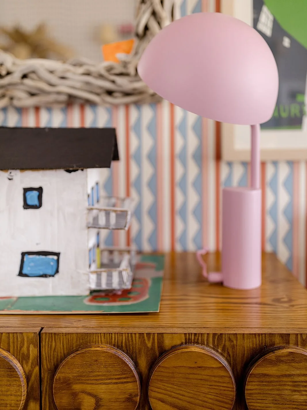 Here are a few little details that bring me and my family joy every day. A cardboard sculpture of our house — made by my oldest before we painted the house pink — proudly displayed right where you walk in.  A wall of kids’ art, meme