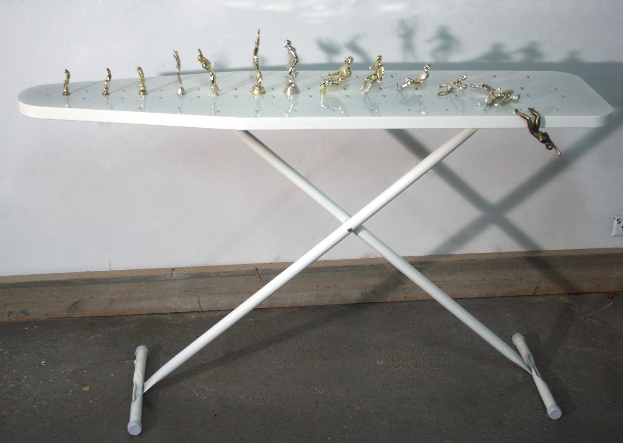 the fall of man. found ironing board + gifted trophies. 2016. 