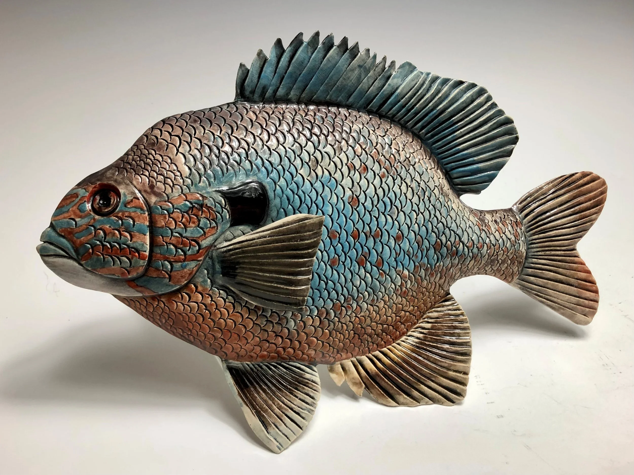Sunfish - Hand Sculpted Raku Low Fire Sculpture with Underglaze
14x9"
Additional Fish Available