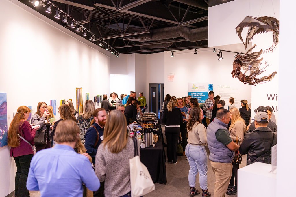 People gathered in a gallery mingling
