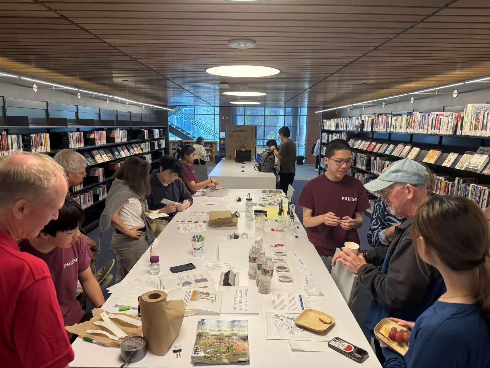 At interactive science stations, high school students shared their learnings on chemistry and ecology with many members of the community at Princeton Public Library.