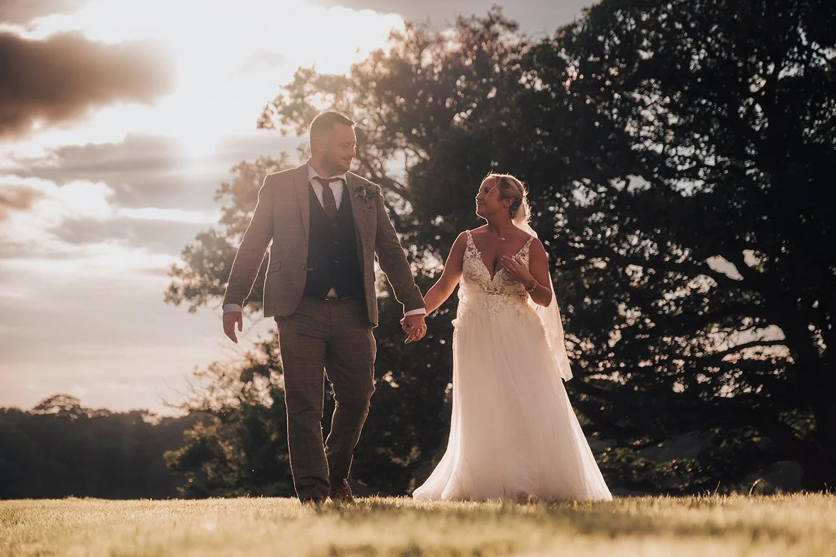 Couple walking through the grounds at golden hour