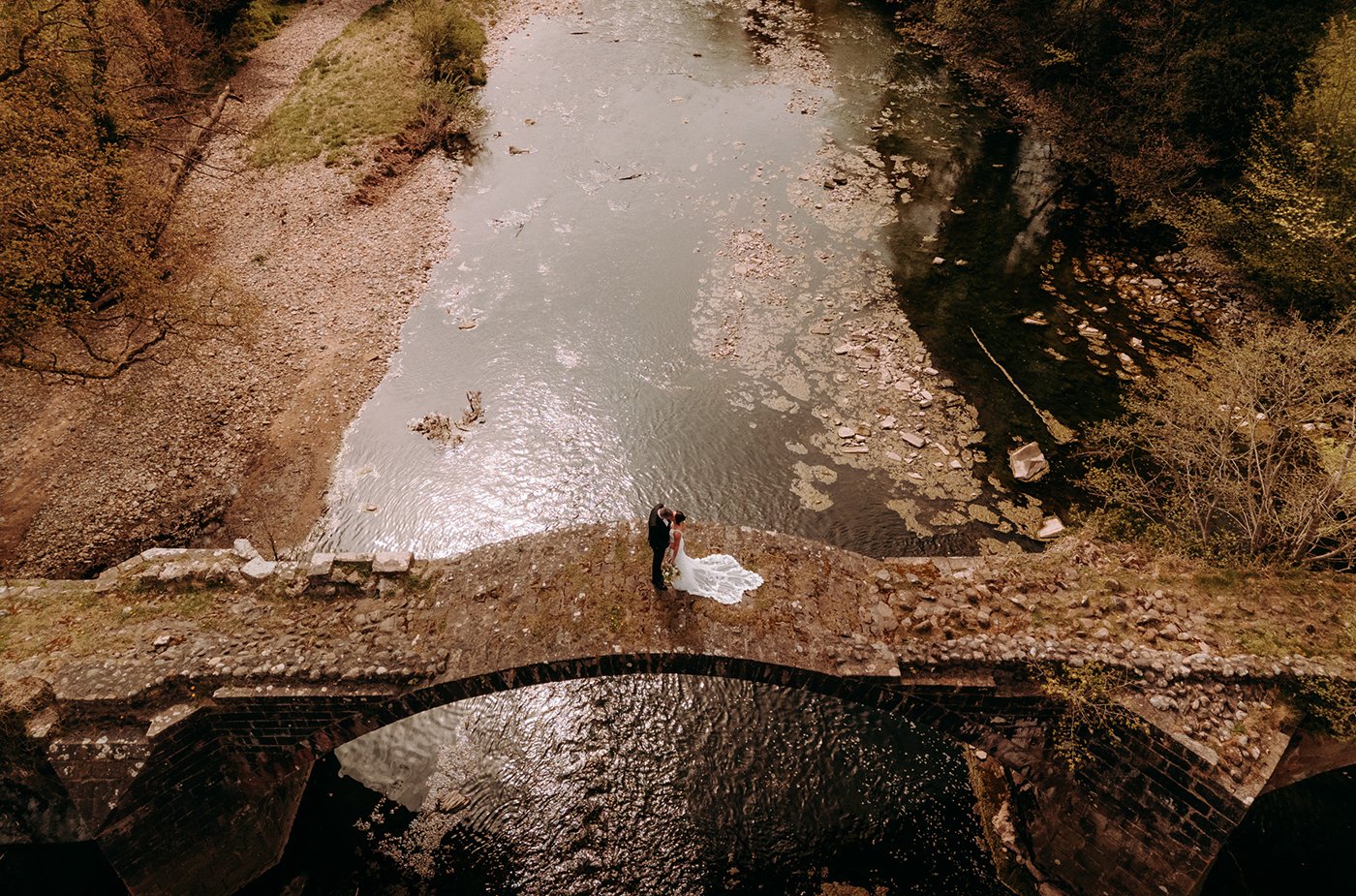 Newlyweds on a stone bridge at a Lancashire wedding