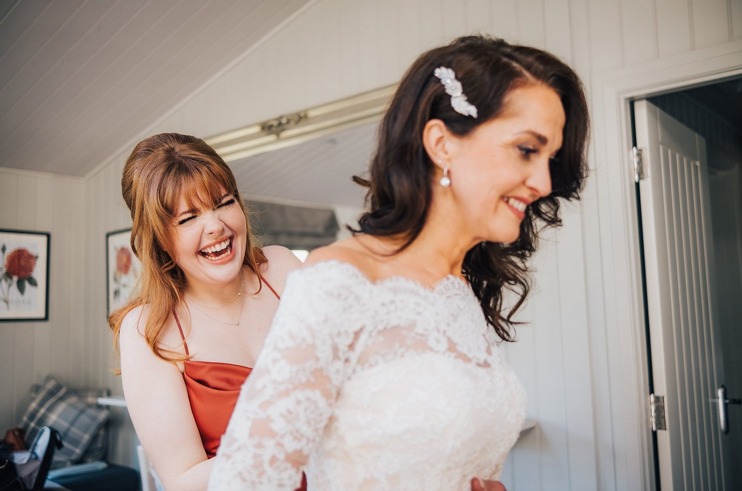 Bride getting ready and laughing on her wedding morning