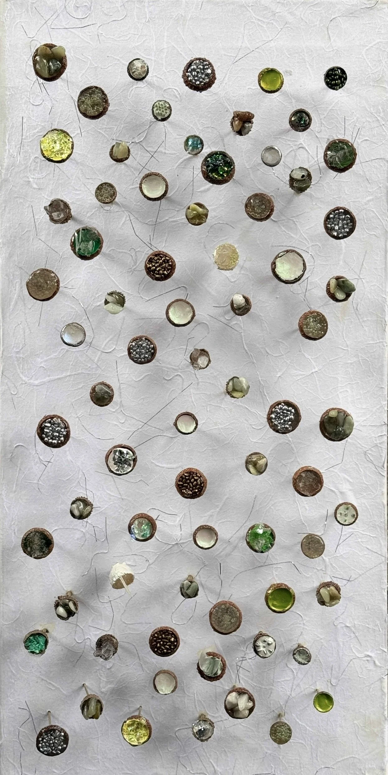 Inspired by biophillia, Treasures in the Fairy's Canopy", features acorn caps and silk worm cocoons that serve as vessels holding delicate treasures. Each vessel is filled quartz crystals, mica, and semi-precious stones then mounted on brass “stems