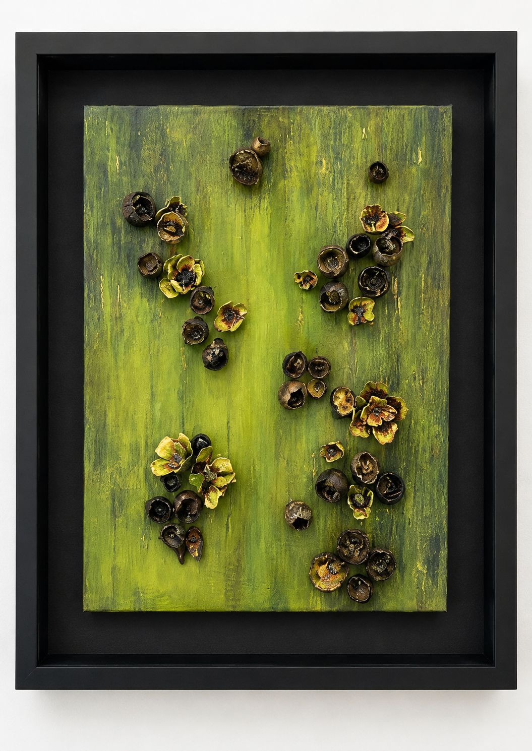 This sculptural relief explores the relationship between organic form, color, texture, and light. Set against a richly layered field of greens, from luminous chartreuse and moss to deeper olive tones, the composition creates the feeling of an evolvin
