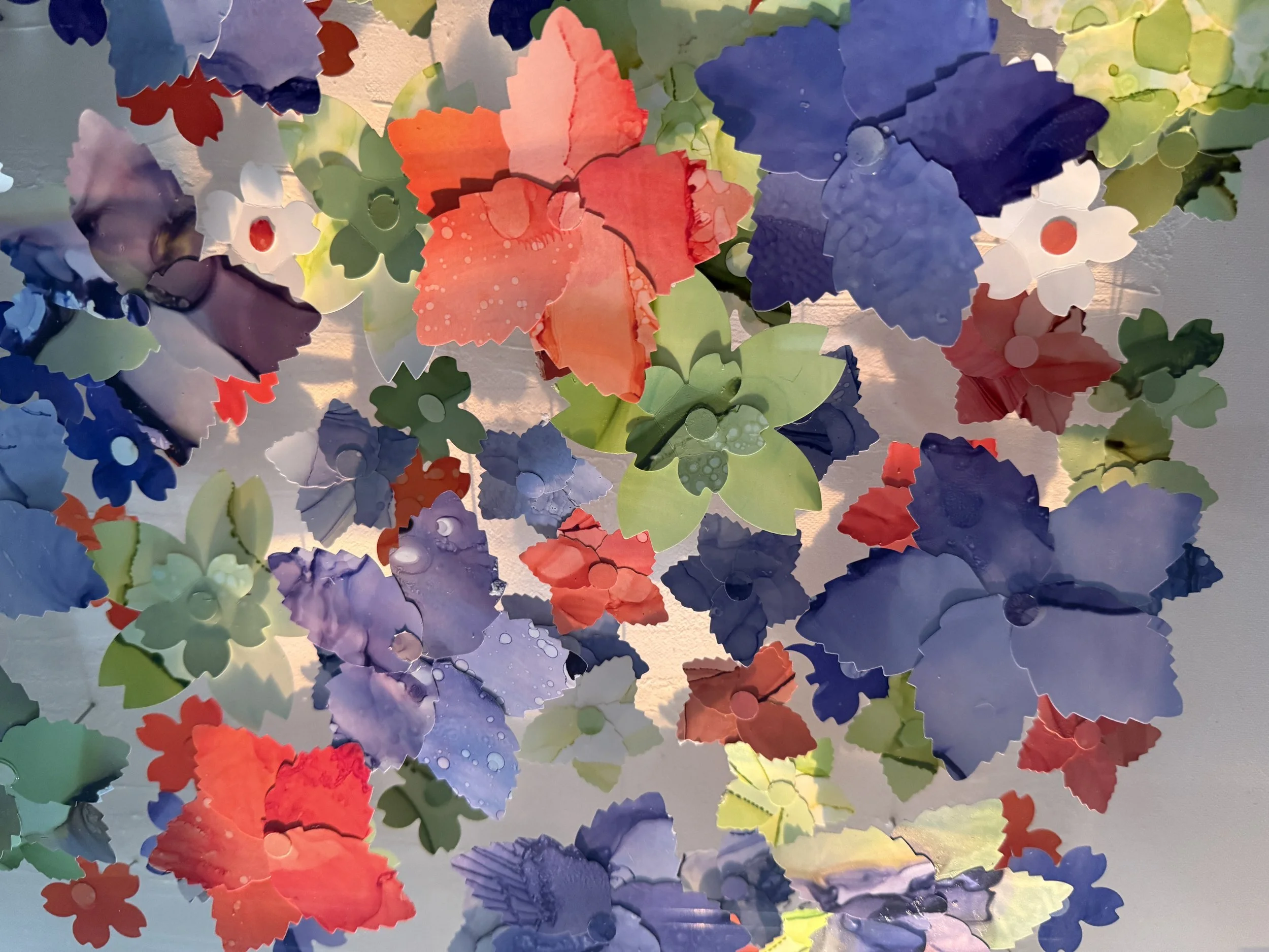 Close up of "Where the Meadow Breathes" custom marbled paper, cut in to thousands of petals and assembled into flowers. Inspired by the rare phenomena of the "super bloom" that sometimes occurs during California's spring time season.