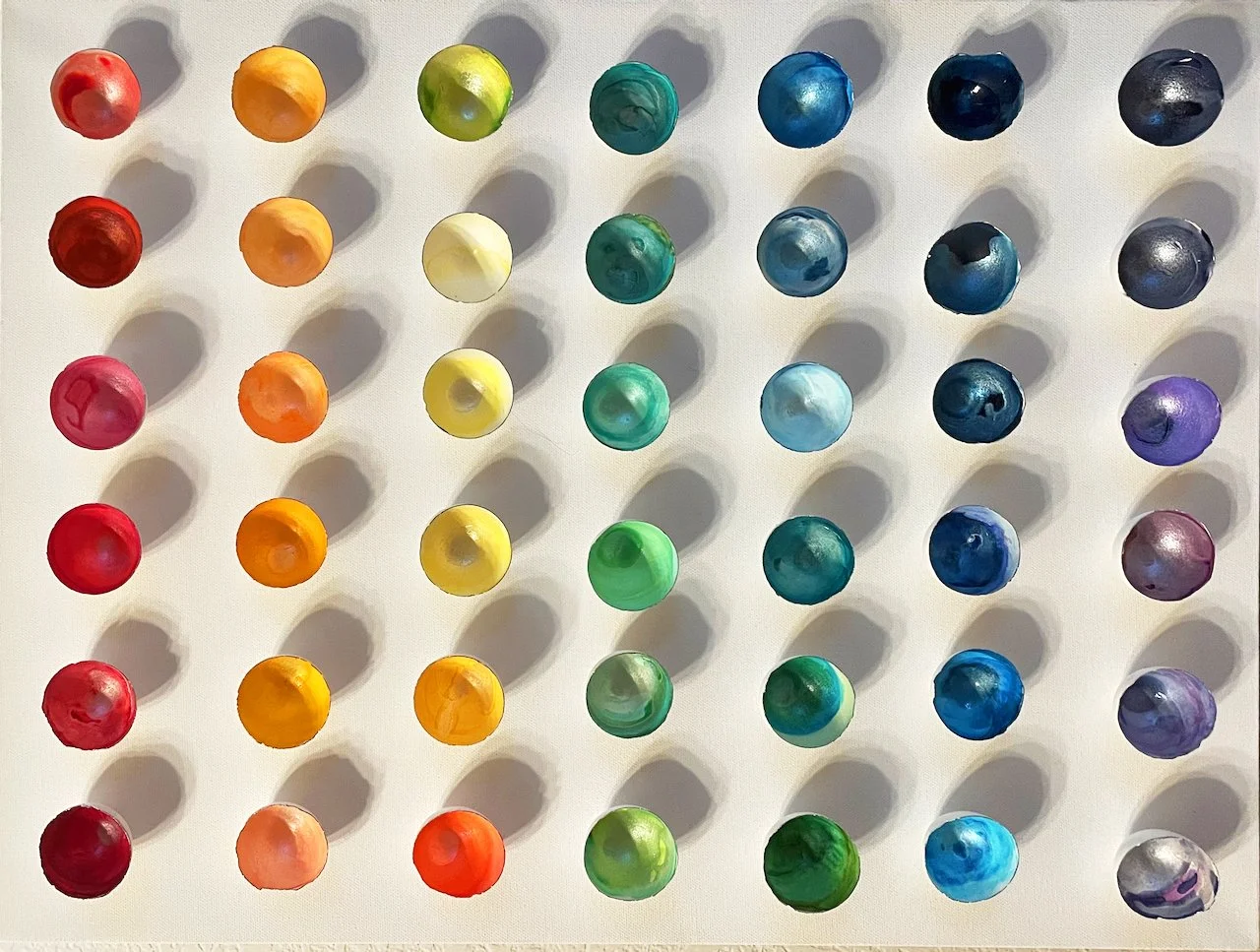 "Chroma" is a loverly array of a spectrum of color. The interior of the eggshells are painted with intense vibrancy with their edges delicately detailed with 18 ct gold. Mounting the eggshells on a white canvas allows the interplay of light to cast s
