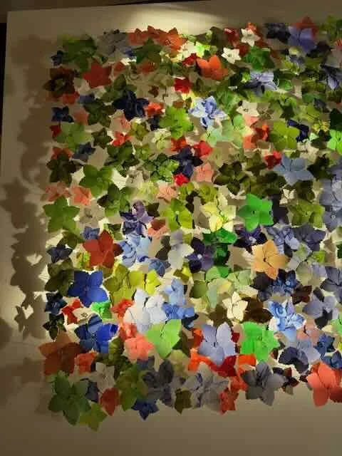 Morning sunlight highlights the 3d feature of "Audrey's Meadow". These hand painted and hand formed flowers are elevated above the canvas allowing light to to cast their shadows.