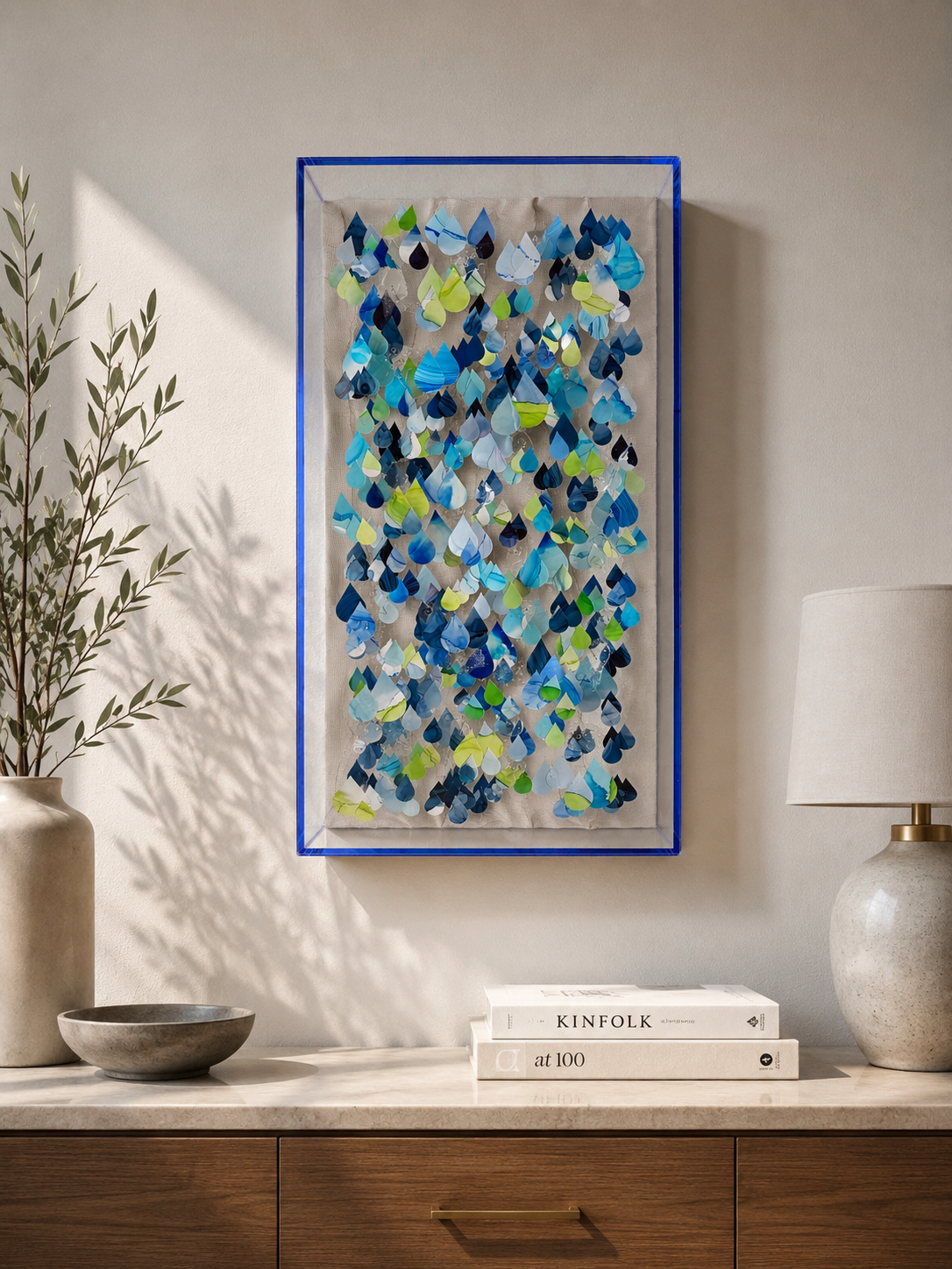 "Breath of Rain" is a sculptural relief inspired by the movement, rhythm, and quiet beauty of rainfall. Custom marbled paper is hand-cut into hundreds of individual layered droplets.   Suspended in space, they create a sense of falling water captured