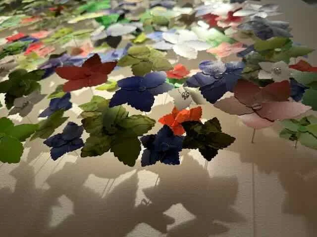 These flowers are mounted to stand away from the canvas revealing the shadows they cast as an additional feature.