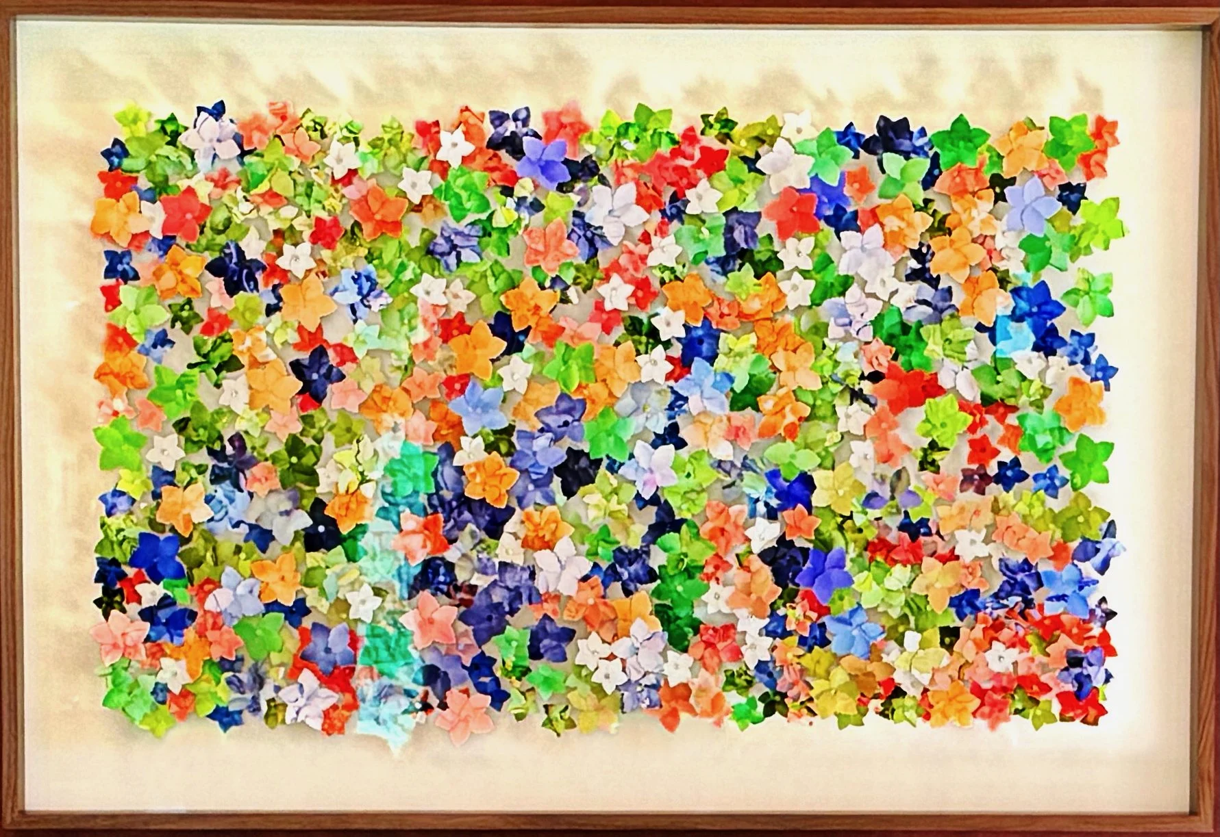 "Audrey’s Meadow" is a joyful exploration of abundance, color, and the quiet wonder found in nature. Hundreds of individually hand cut flowers come together in a richly layered field, creating the impression of a meadow captured at the height of bloo