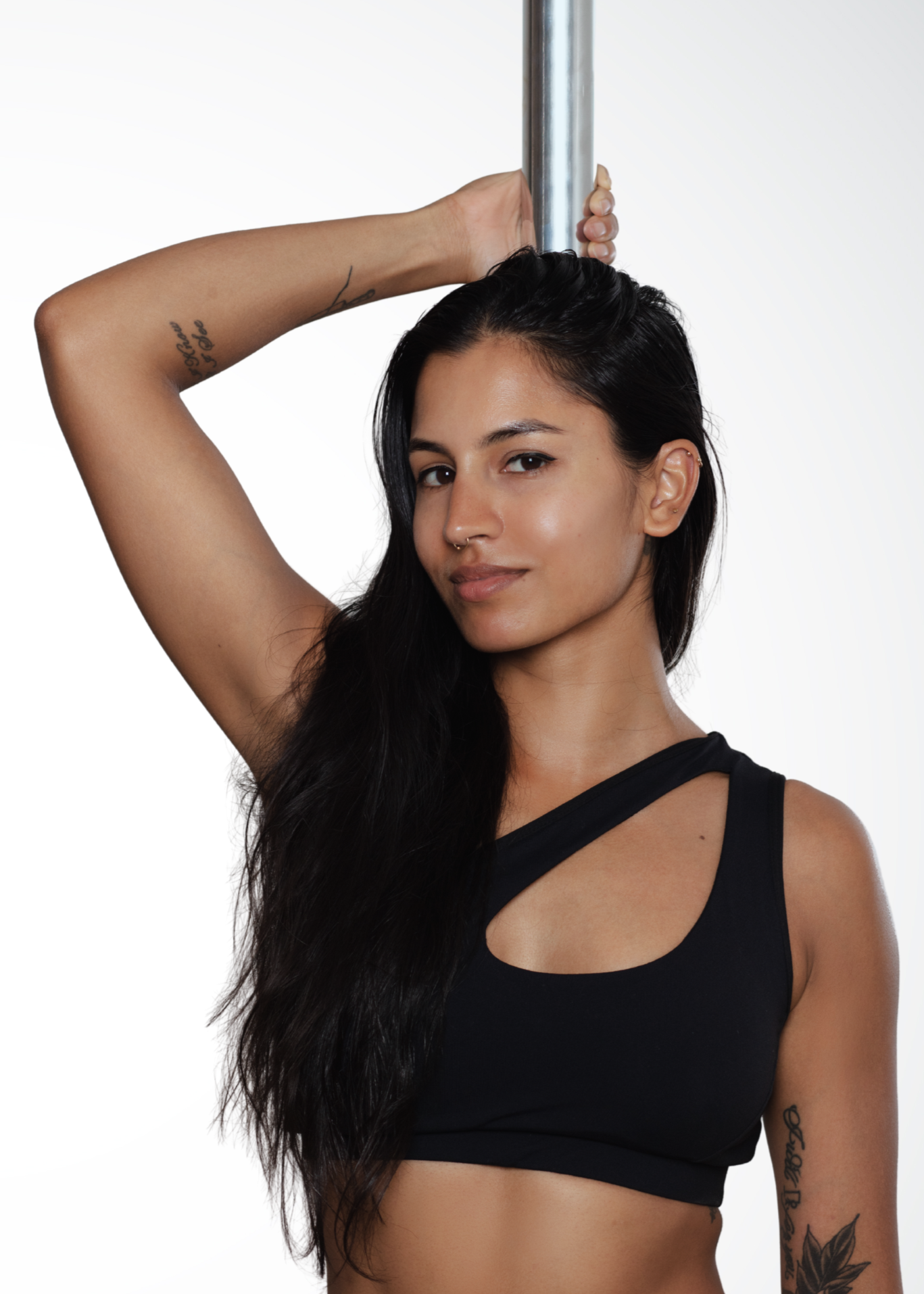 Sonali spin pole instructor in NYC demonstrating aerial pole technique and strength at Full Circle