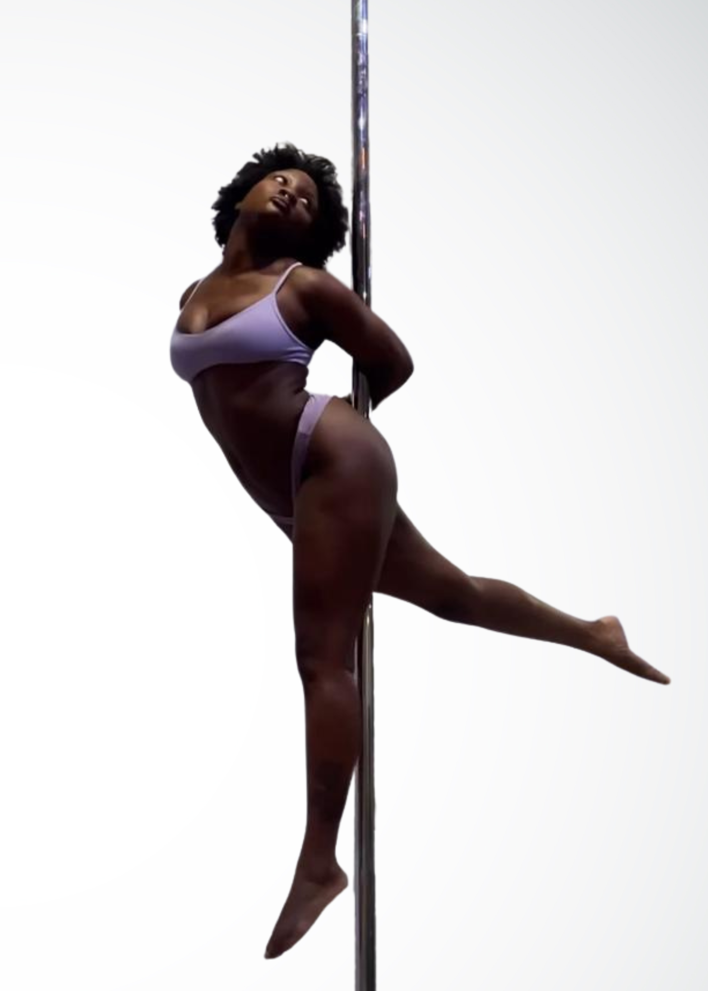 Cassandra spin pole instructor in Brooklyn performing aerial pole shapes with strength and softness