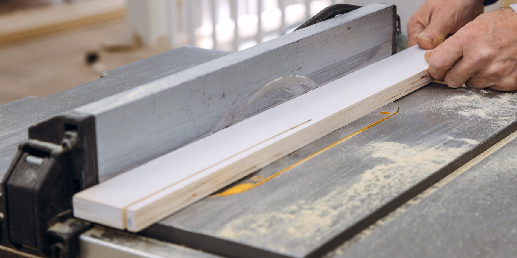master craftsman using a wooden board in custom millwork