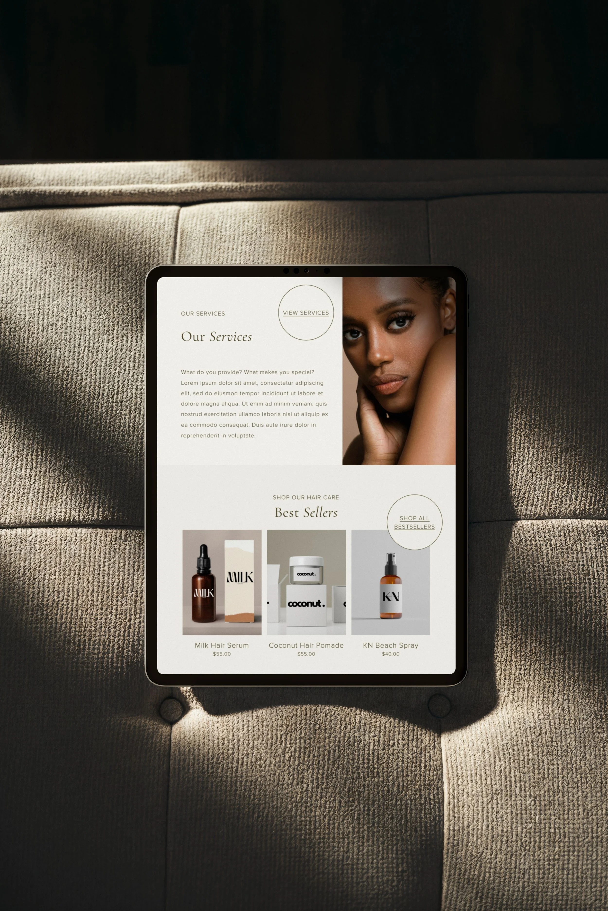A tablet sitting on a chair displaying a salon website design