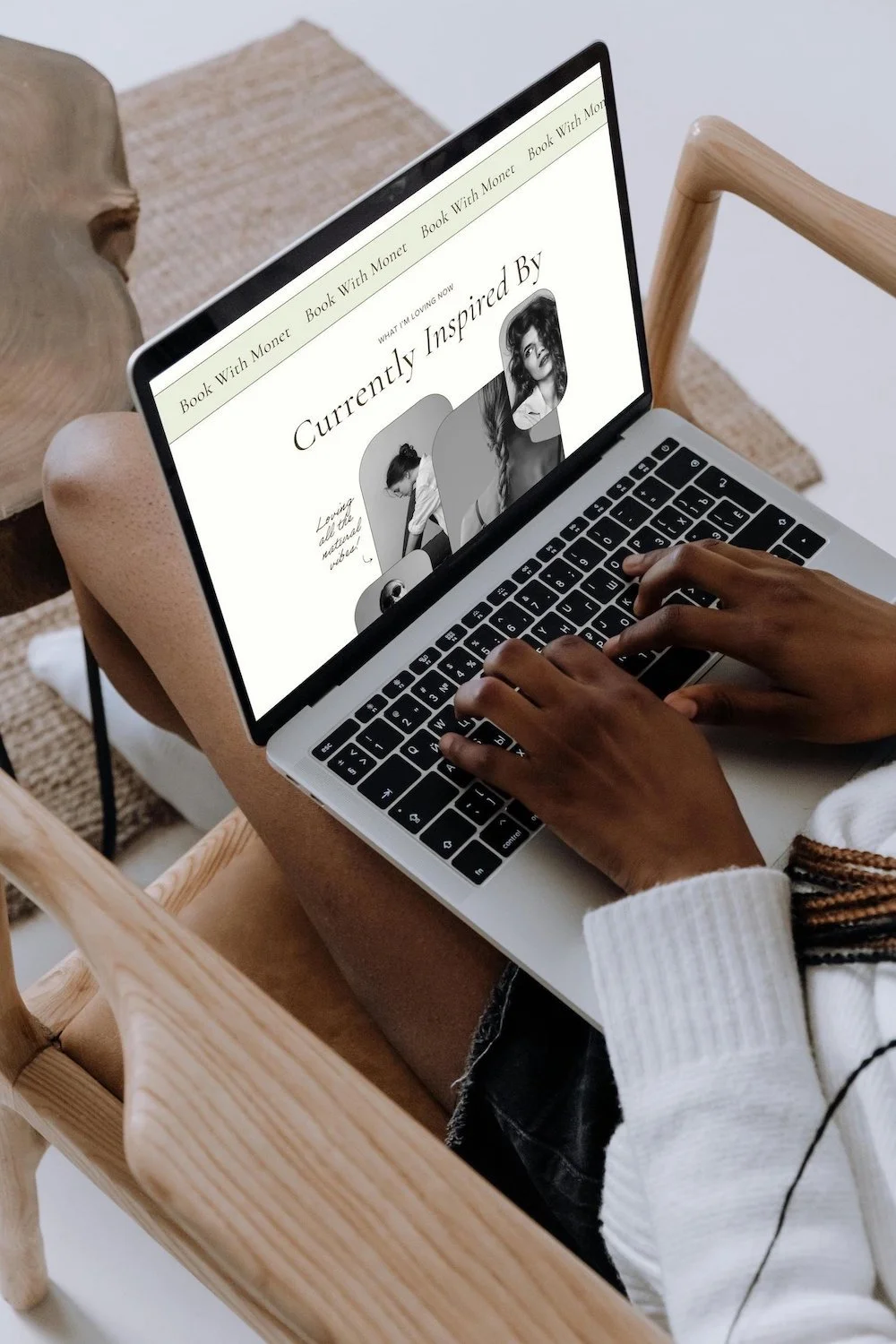 A woman sits with her laptop on her lap browsing the demo website for the esi squarespace 7.1 template