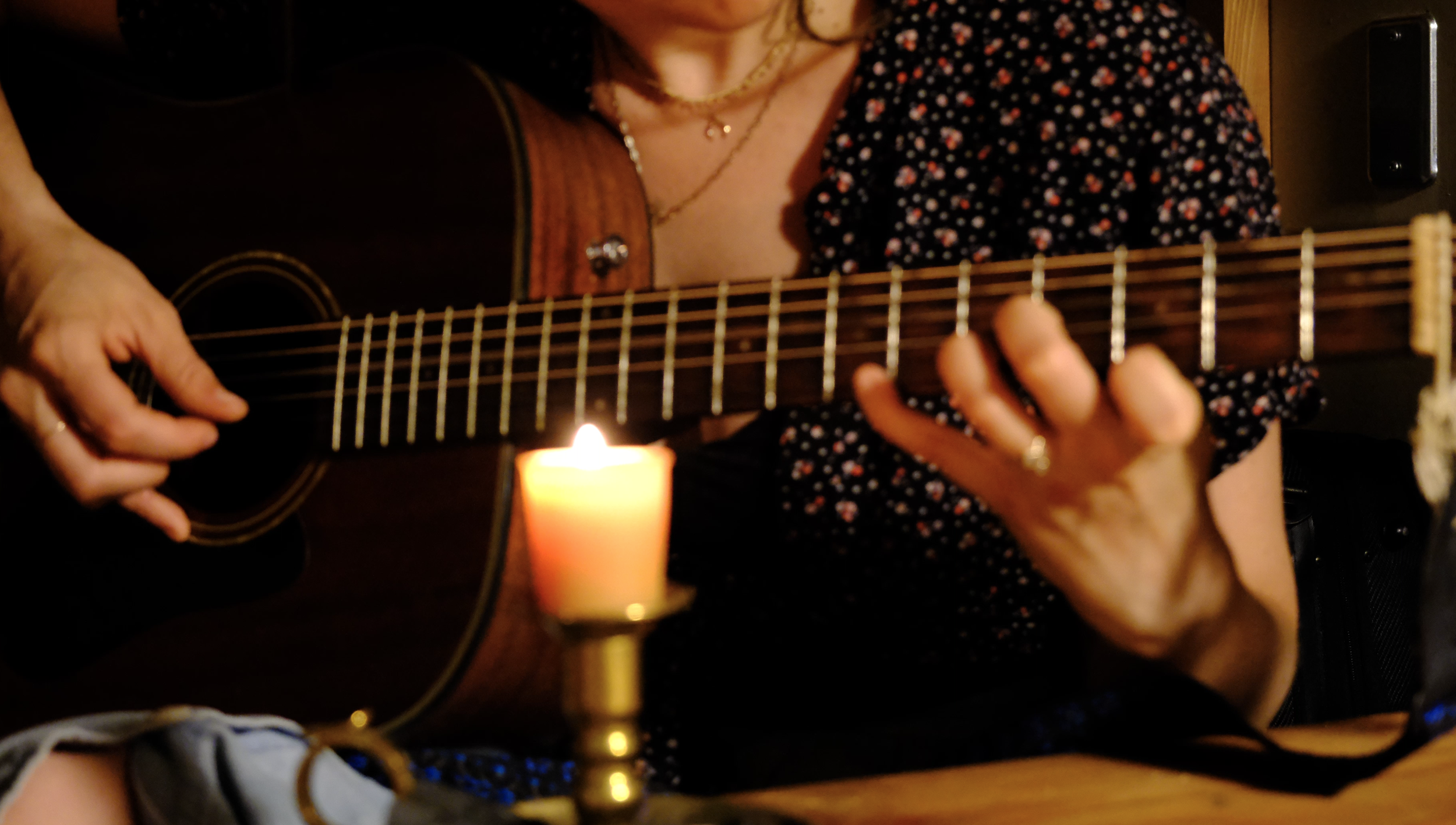 shows colse up of guitar played by candlelight. Creative hobbies are part of both burnout recovery and prevention, but there are key differences