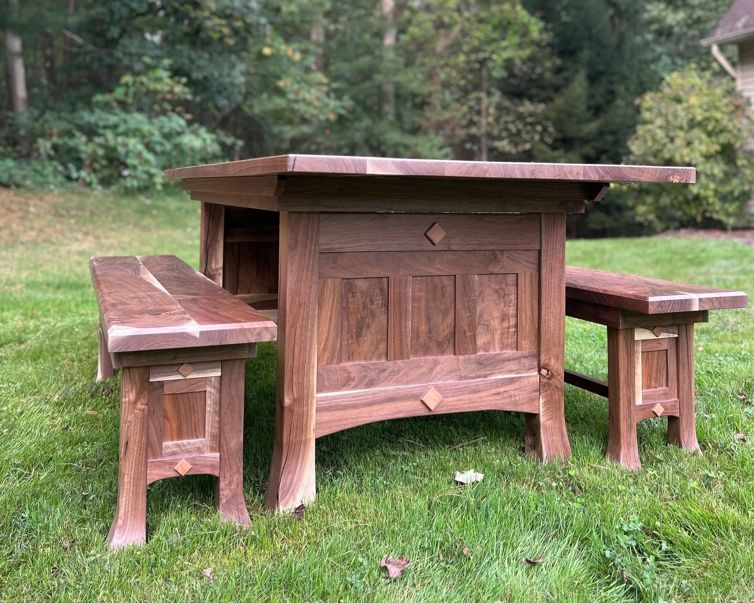 Custom walnut dining table and matching benches made from a tree on the client’s property