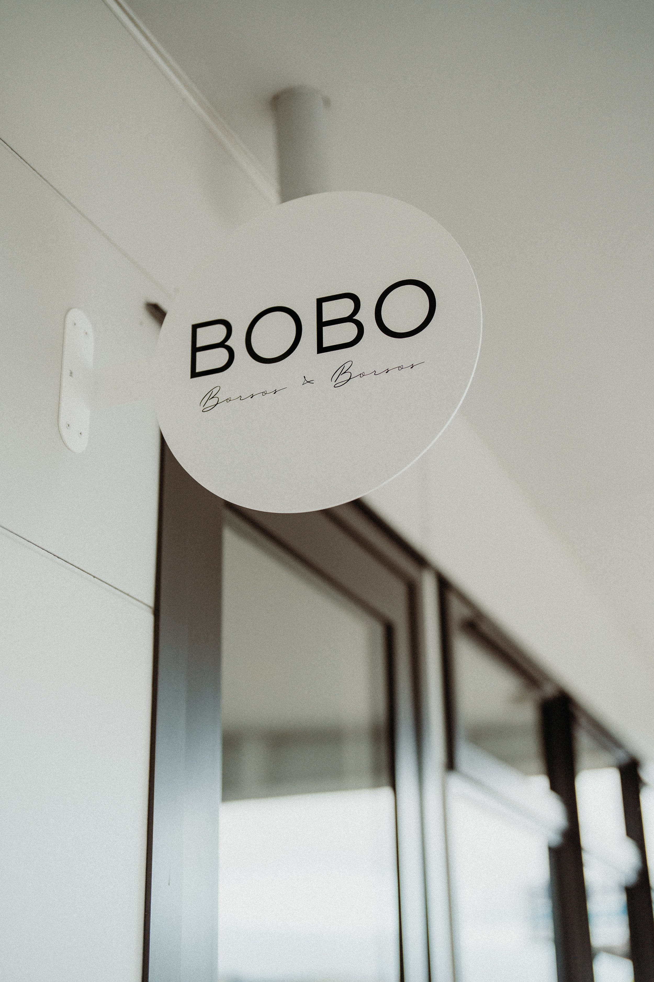 Sign reading 'BOBO' outside a shop or business entrance.