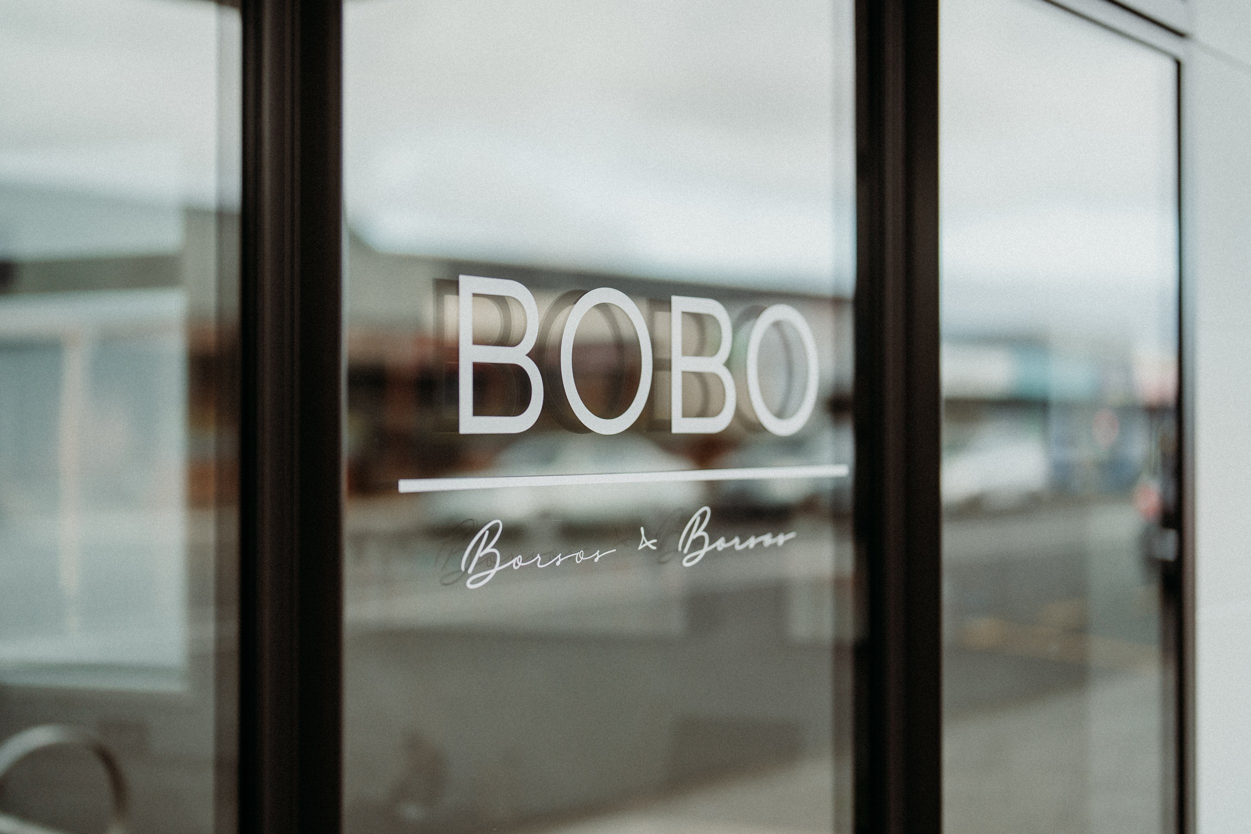 Glass door with 'BOBO' and 'Boros & Burns' text