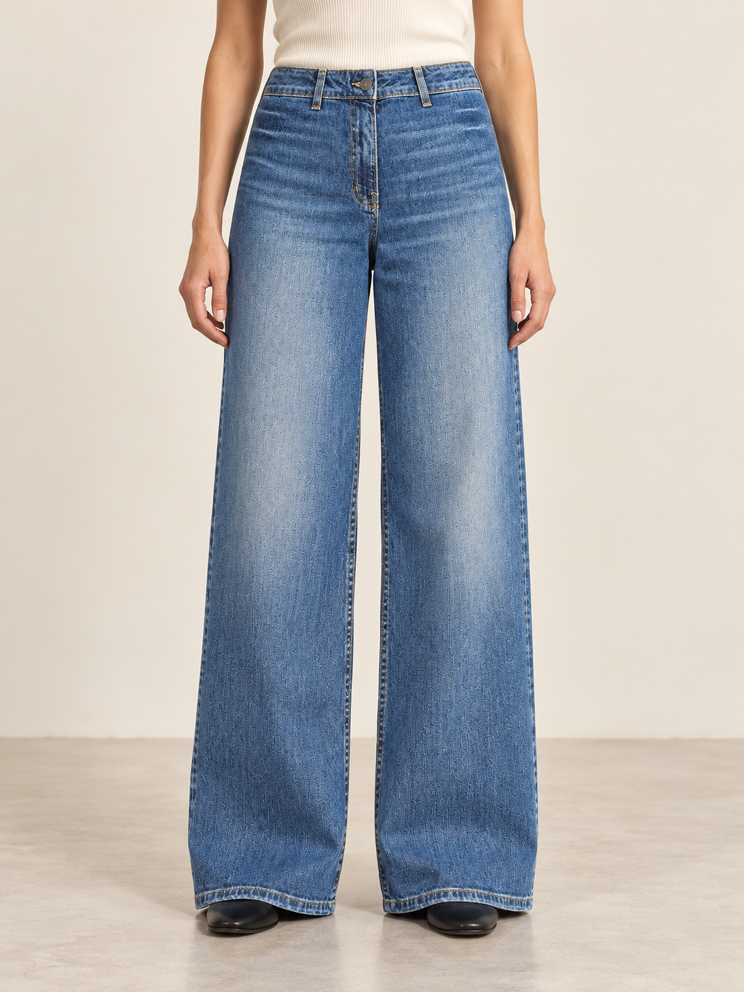 Luxury wide-leg denim studio portrait.png