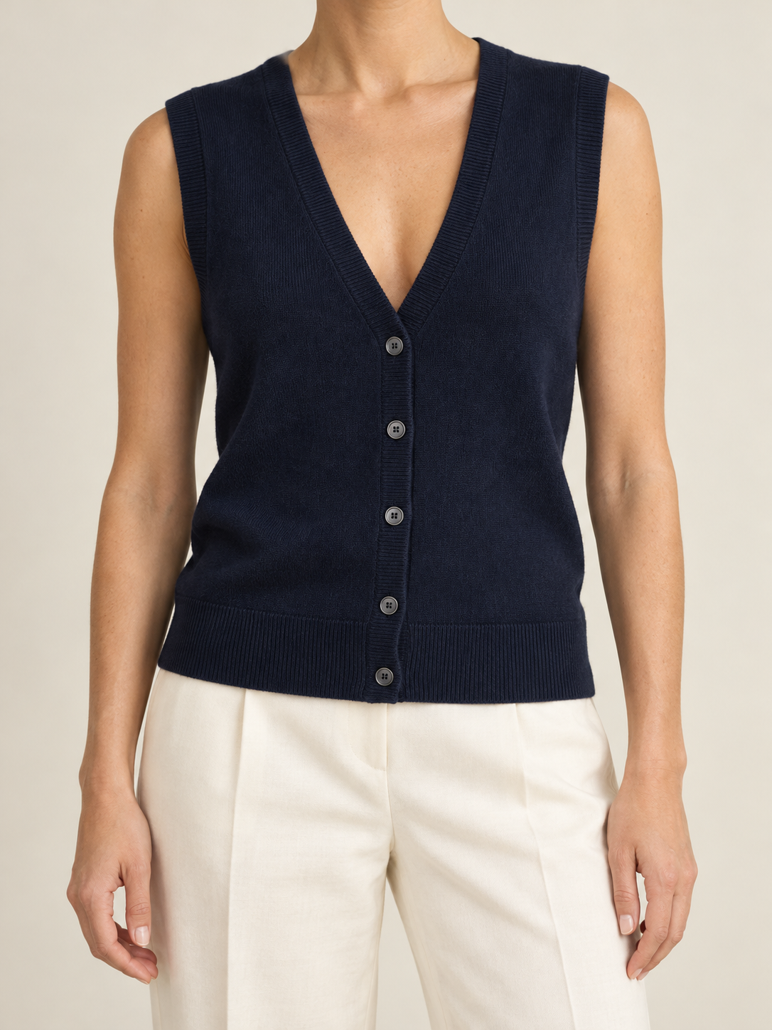 Navy Knit Vest with Ivory Trousers.png