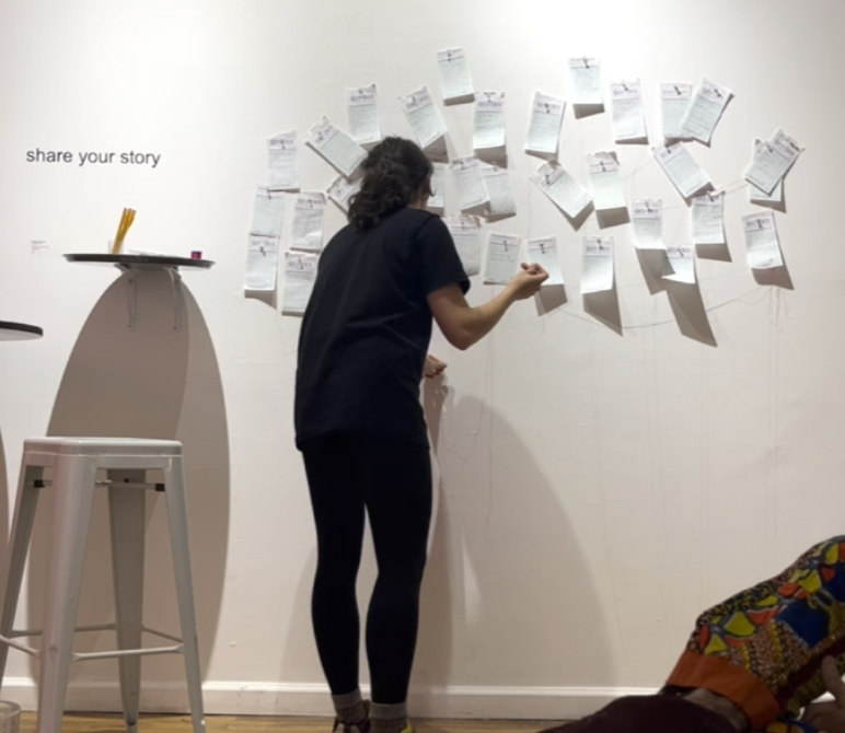 During her performance, The artist read each story aloud, repeating words and phrases over and over, as she stitched each story together, creating a visual symbol of connection.