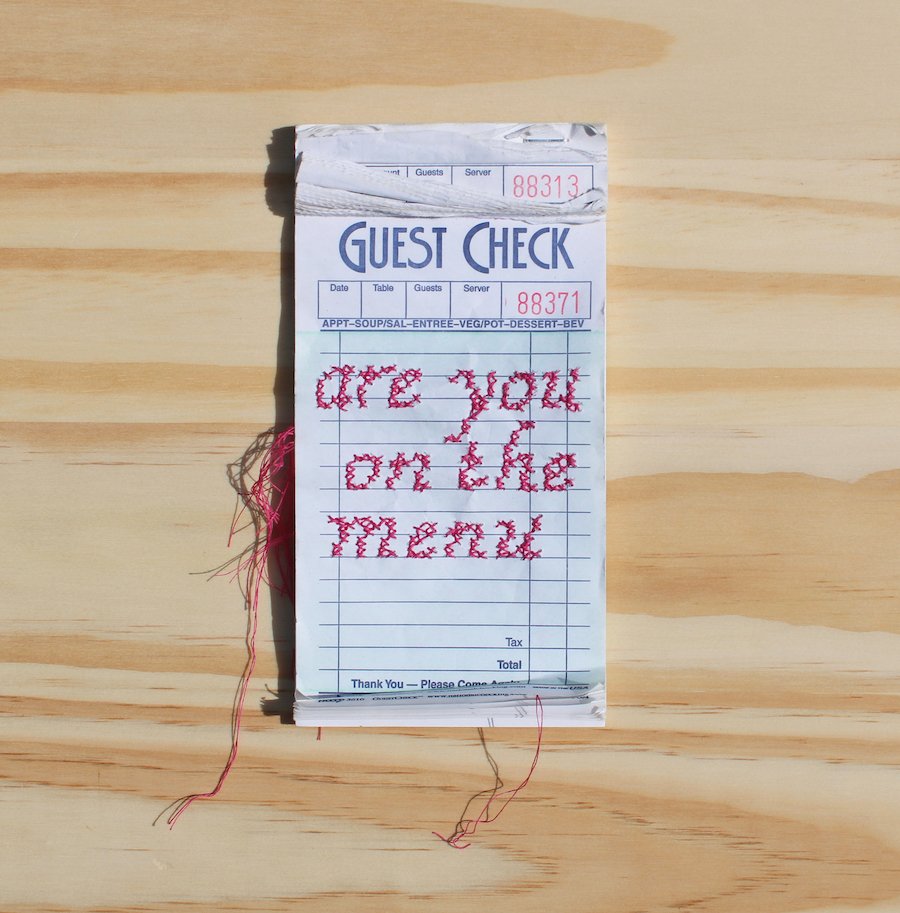 Morgan Bukovec_are you on the menu_2022_6.75” x 3.5”_cross stitch on guest checkbook_ copy.jpg