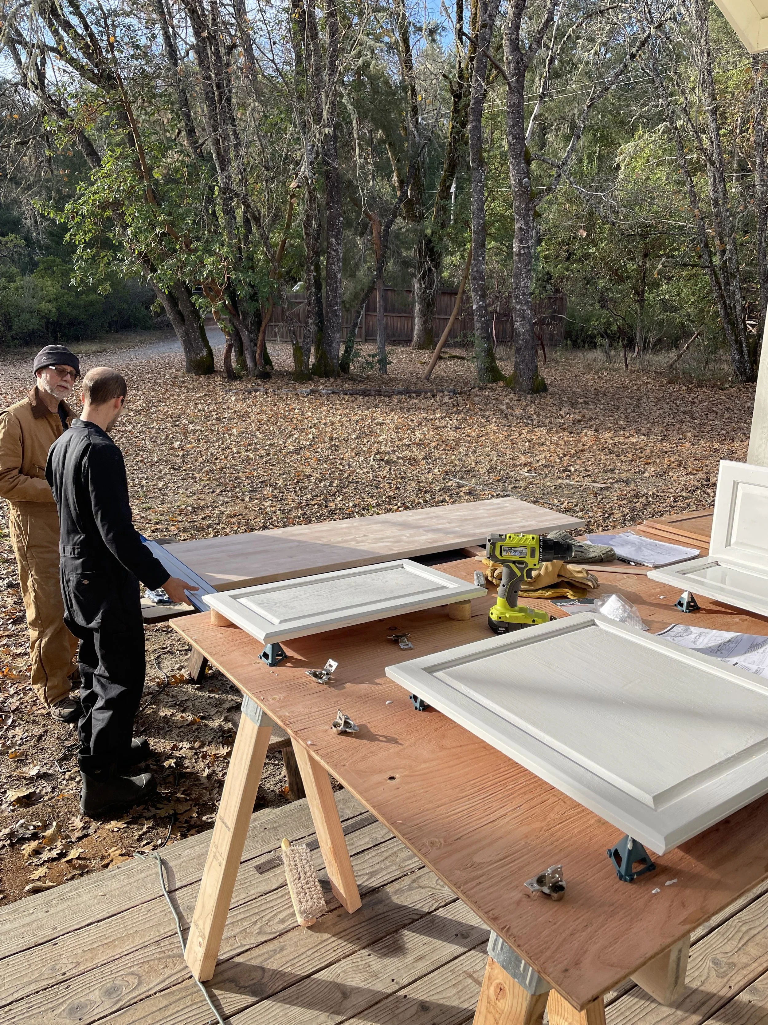 Letting cabinet doors dry and prepping the butcher block countertops