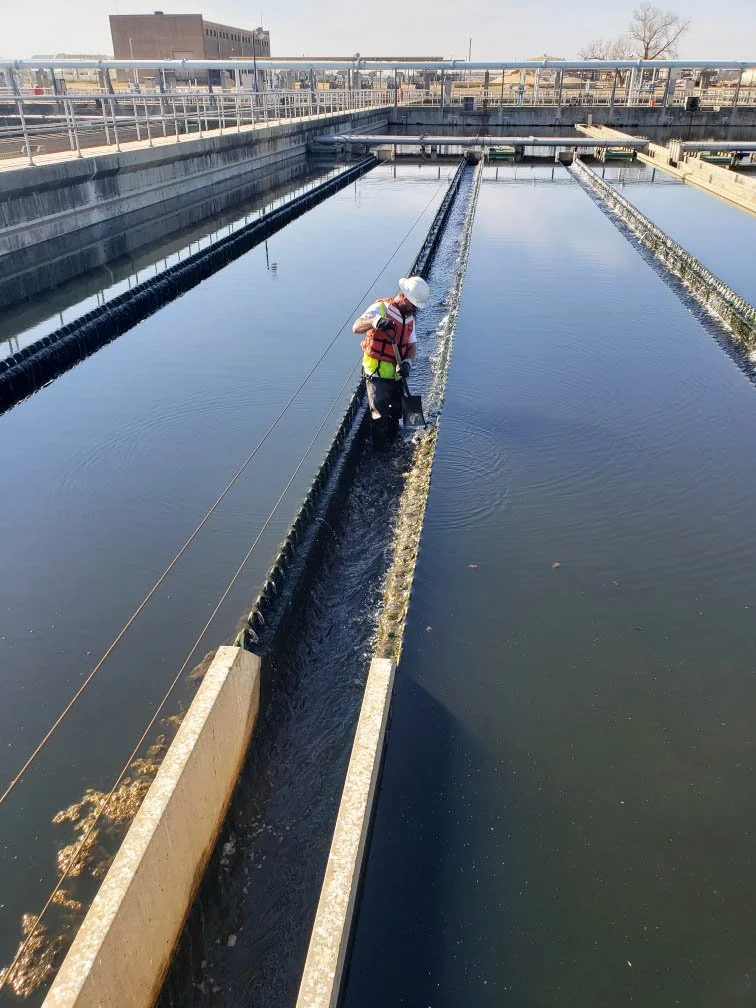 JG_shoveling channel on one clarifier.jpeg