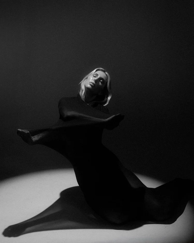 Black and white portrait of a woman in a spotlight