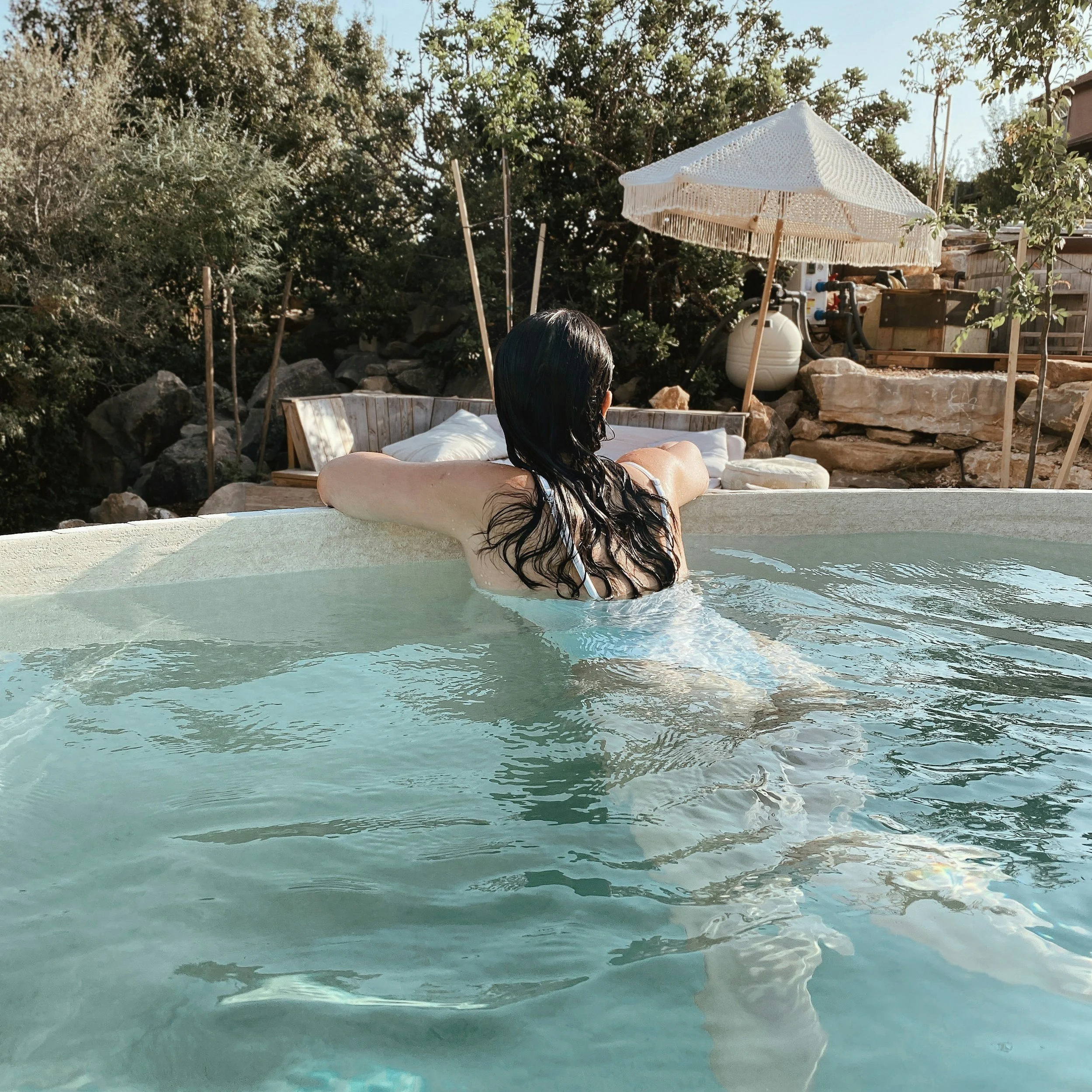 woman relaxing by a pool, —perfect for Anxiety therapy in Miami.