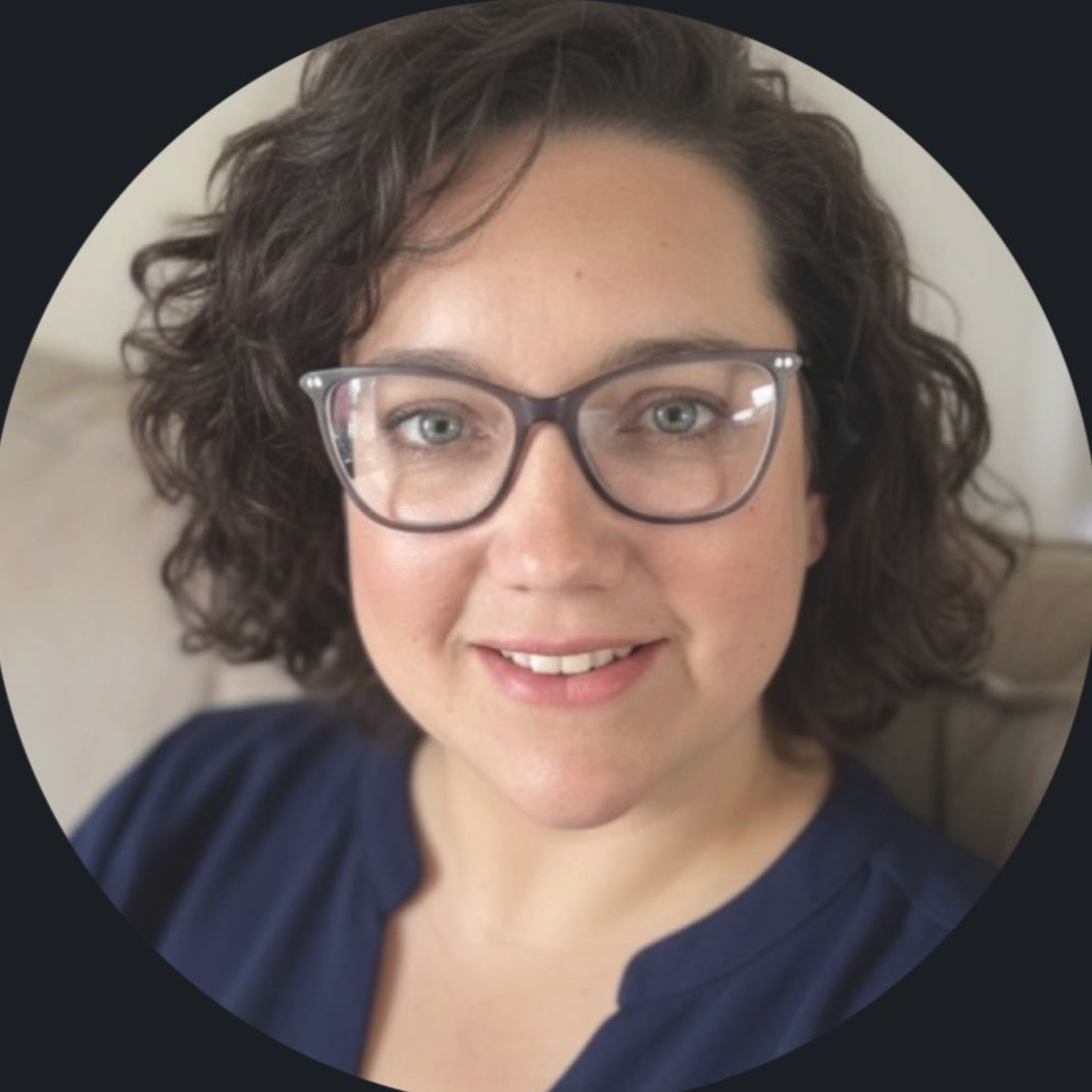 Website designer Karin smiling at camera in navy blue shirt