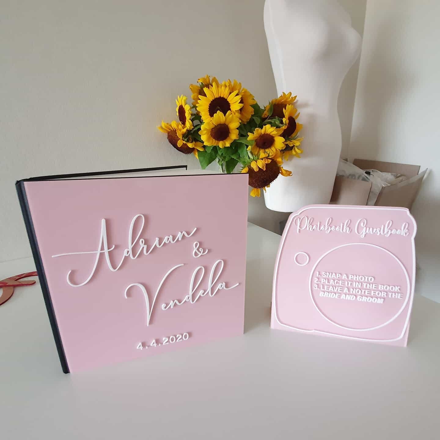 Here's a great way to personalise your photo book and photo area at any wedding. 
This sign and cover have both been back sprayed and had white acrylic lettering laminated to the front side to give a high gloss acrylic look all round.