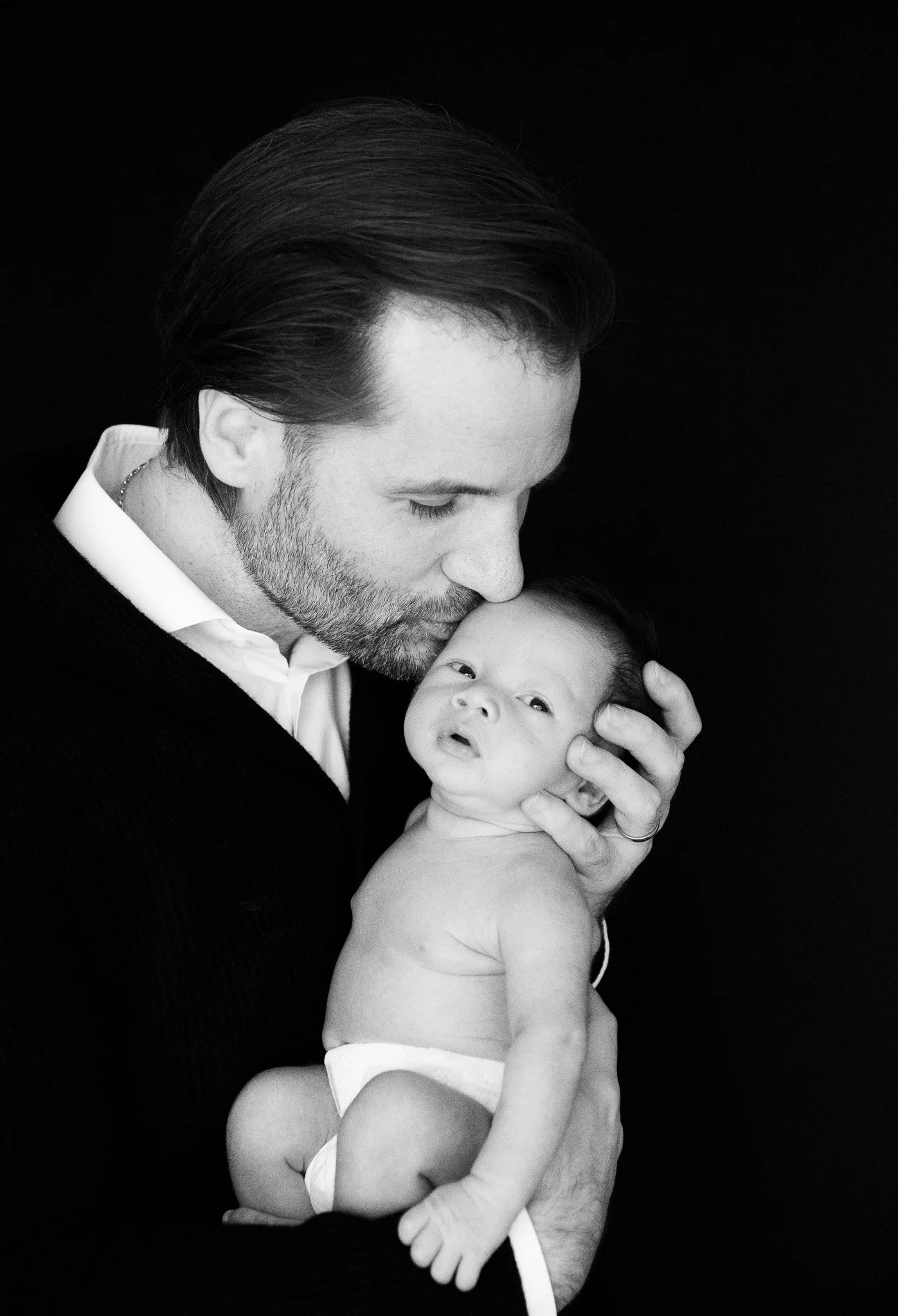 Snuggle Pix Family Photographer | Daddy kisses newborn baby boy on the head | Noosa | Sunshine Coast | Brisbane.jpg